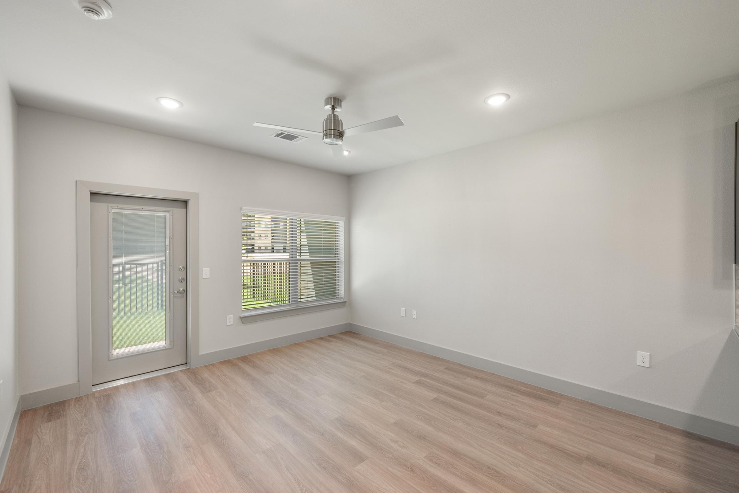 Open living area in the A1 unit with natural light, neutral tones, and direct access to the kitchen and dining space.