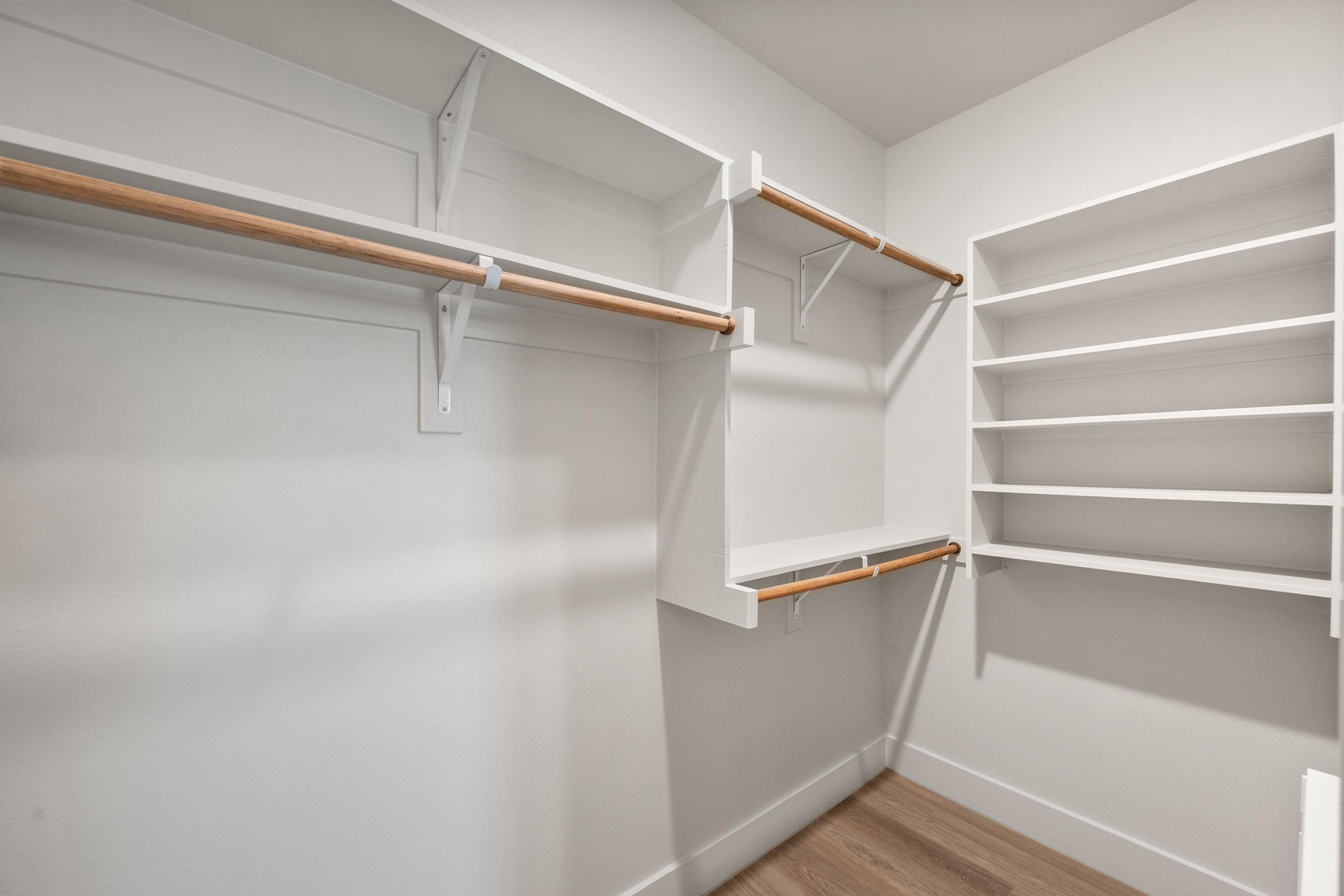 Walk-in closet in the A1 unit with built-in shelving and generous hanging space, accessible through the bathroom.