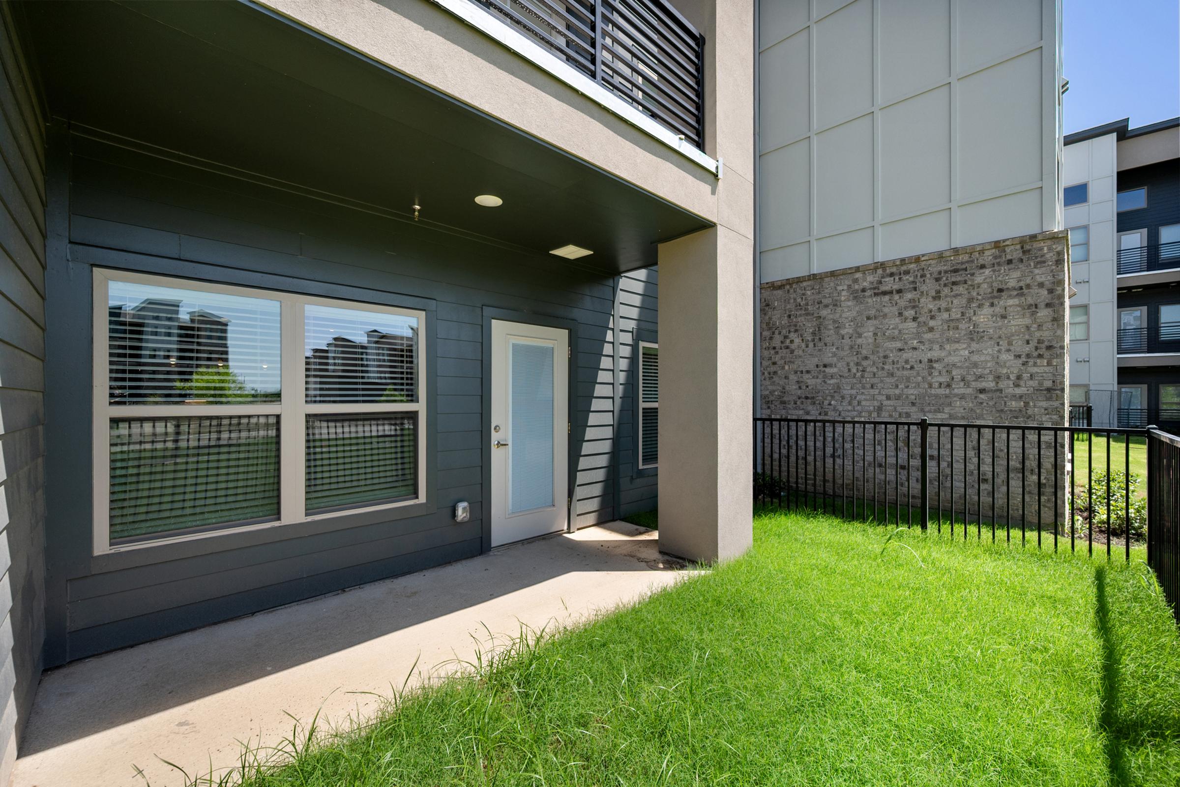 Private patio with an attached pet yard in the A1 Floor Plan at The Emma Apartments, offering outdoor space perfect for relaxing and pet-friendly living.