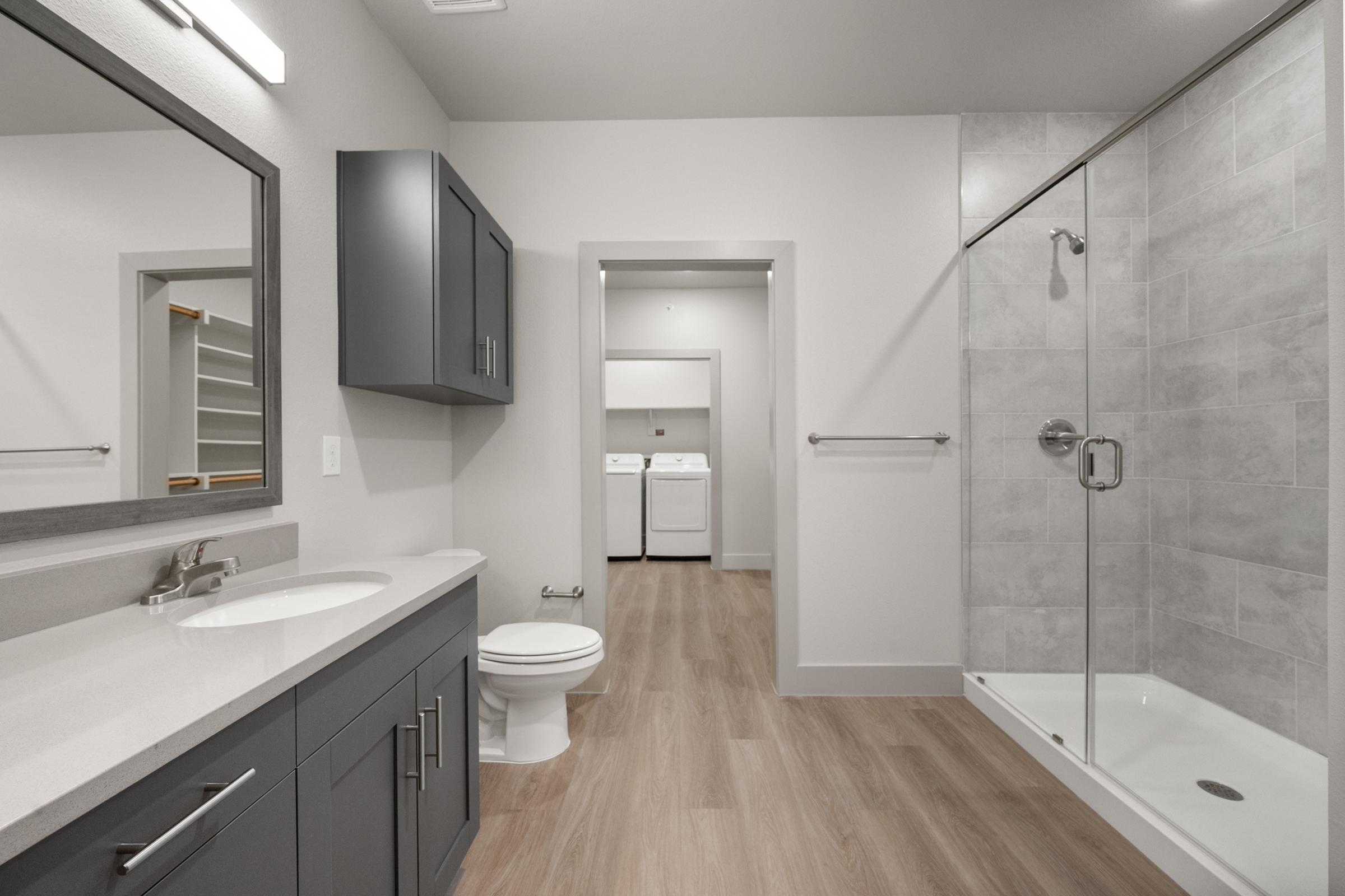 Bathroom in the A2 Floor Plan featuring a modern walk-in shower, sleek vanity, and contemporary fixtures for a clean, spacious feel.