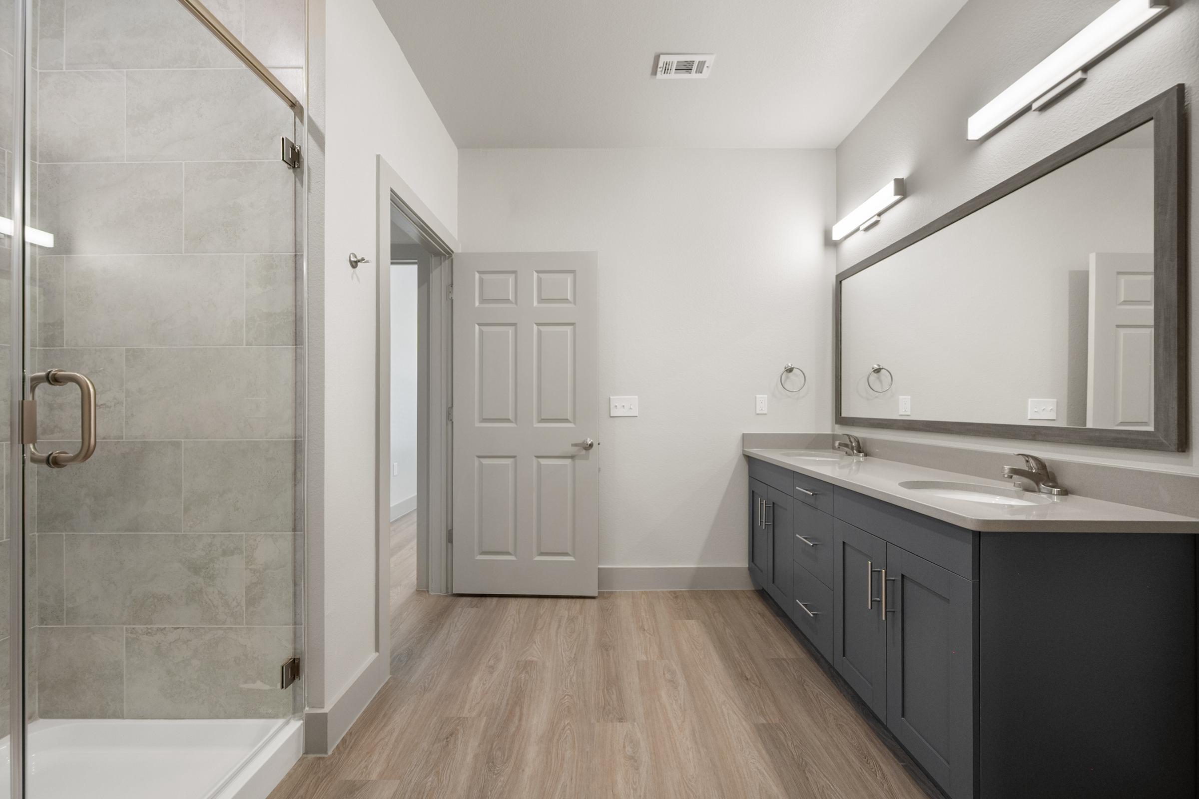 Bathroom in the A2 Floor Plan featuring a modern walk-in shower, sleek vanity, and contemporary fixtures for a clean, spacious feel.