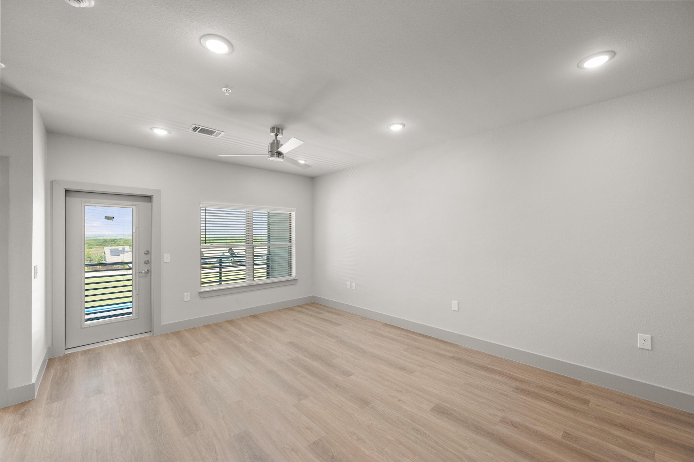 Open-concept living area in the A3 Floor Plan at The Emma Apartments with natural light and spacious layout.