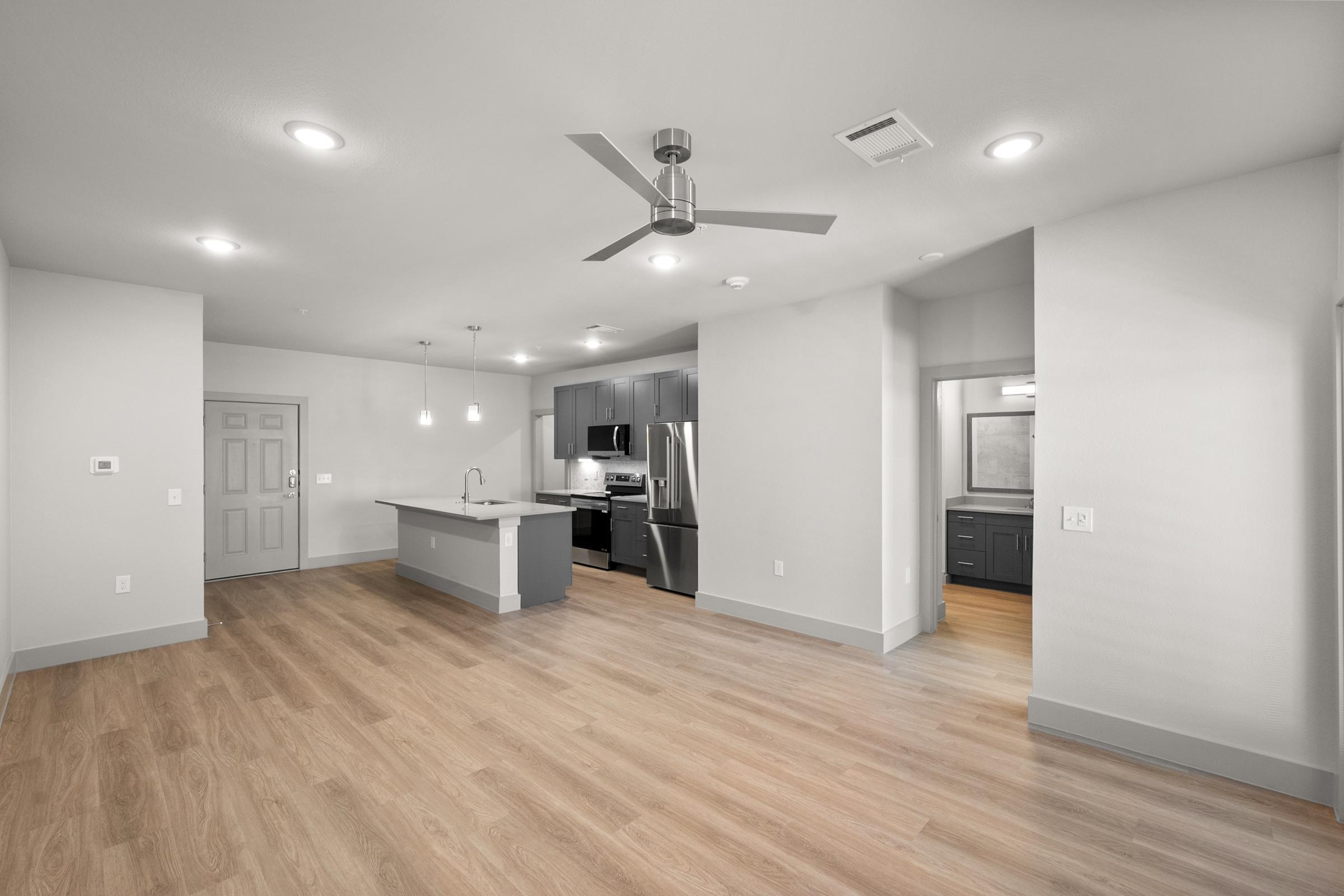 Open-concept living area in the A3 Floor Plan at The Emma Apartments with natural light and spacious layout.