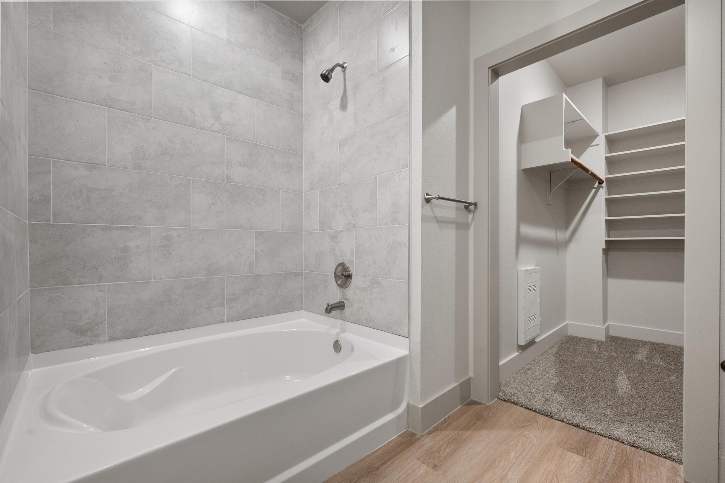 Bathroom with shower-tub combination and contemporary fixtures in the A3 Floor Plan at The Emma Apartments.