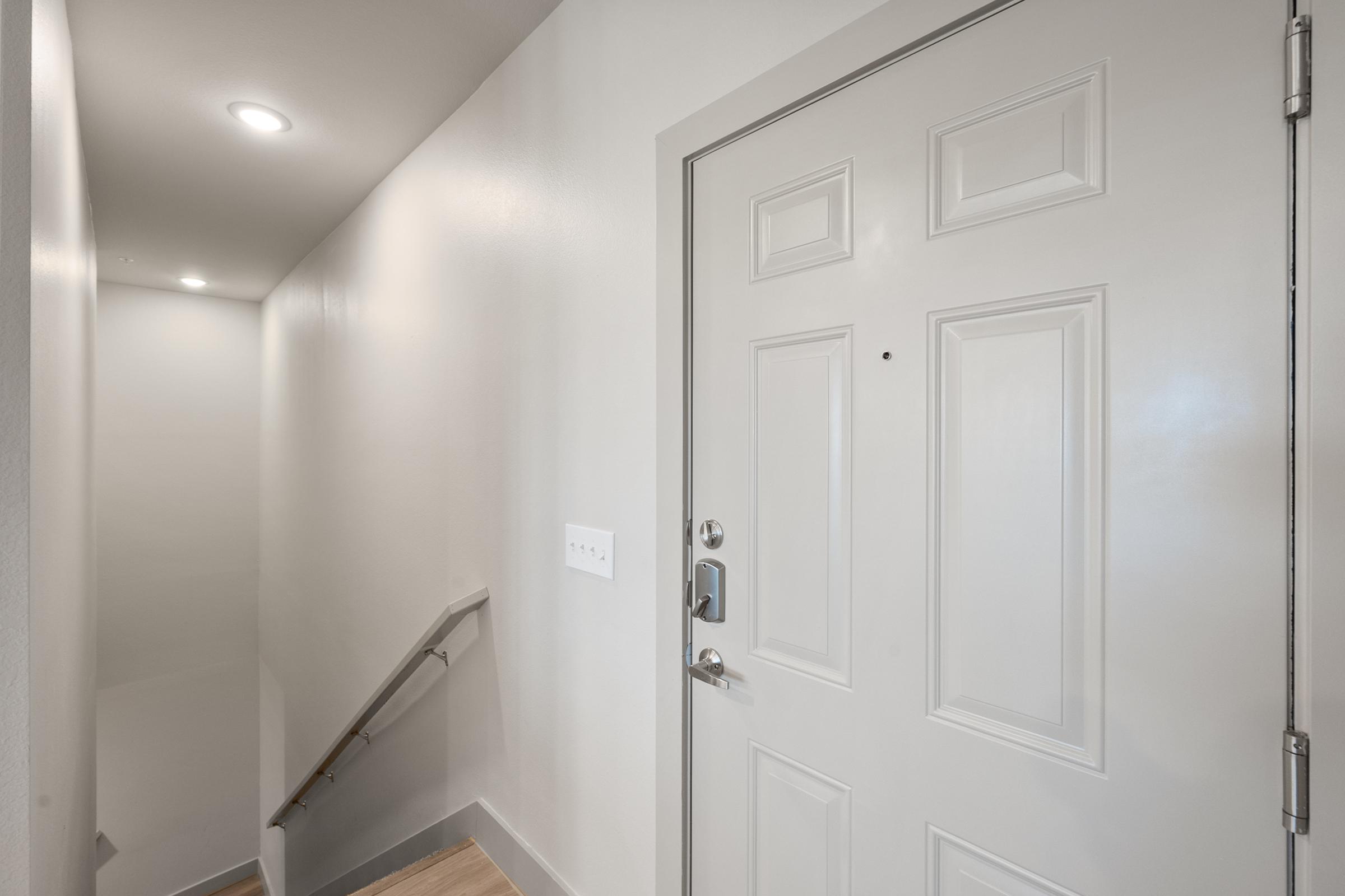 Interior private staircase leading from the garage level to the main living area in the A4 townhome-style unit.