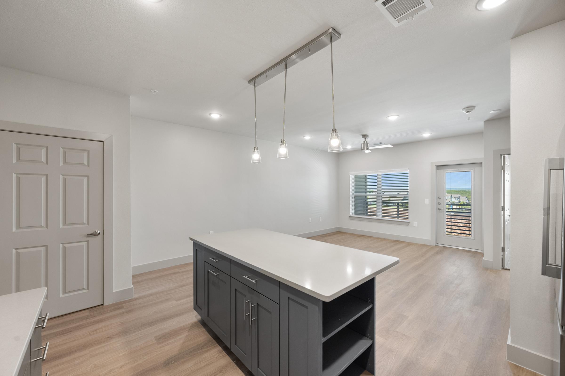 Modern kitchen in the A4 Floor Plan with stainless steel appliances, quartz countertops, and an open layout connected to the living area.
