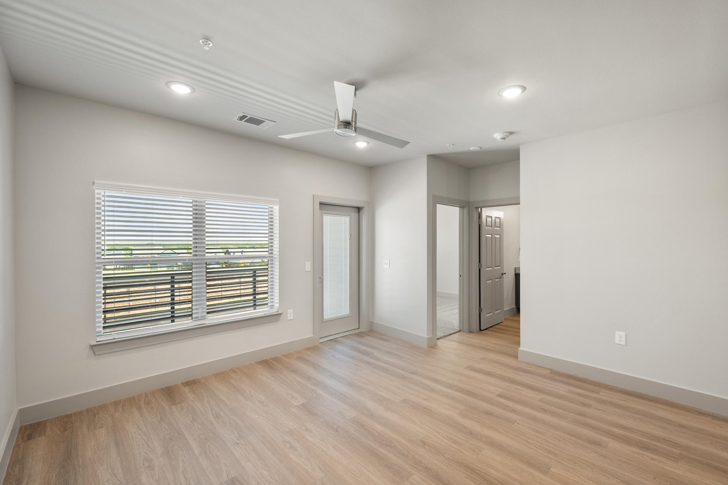 Open-concept living area in the A4 Floor Plan featuring high ceilings, natural light, and contemporary design