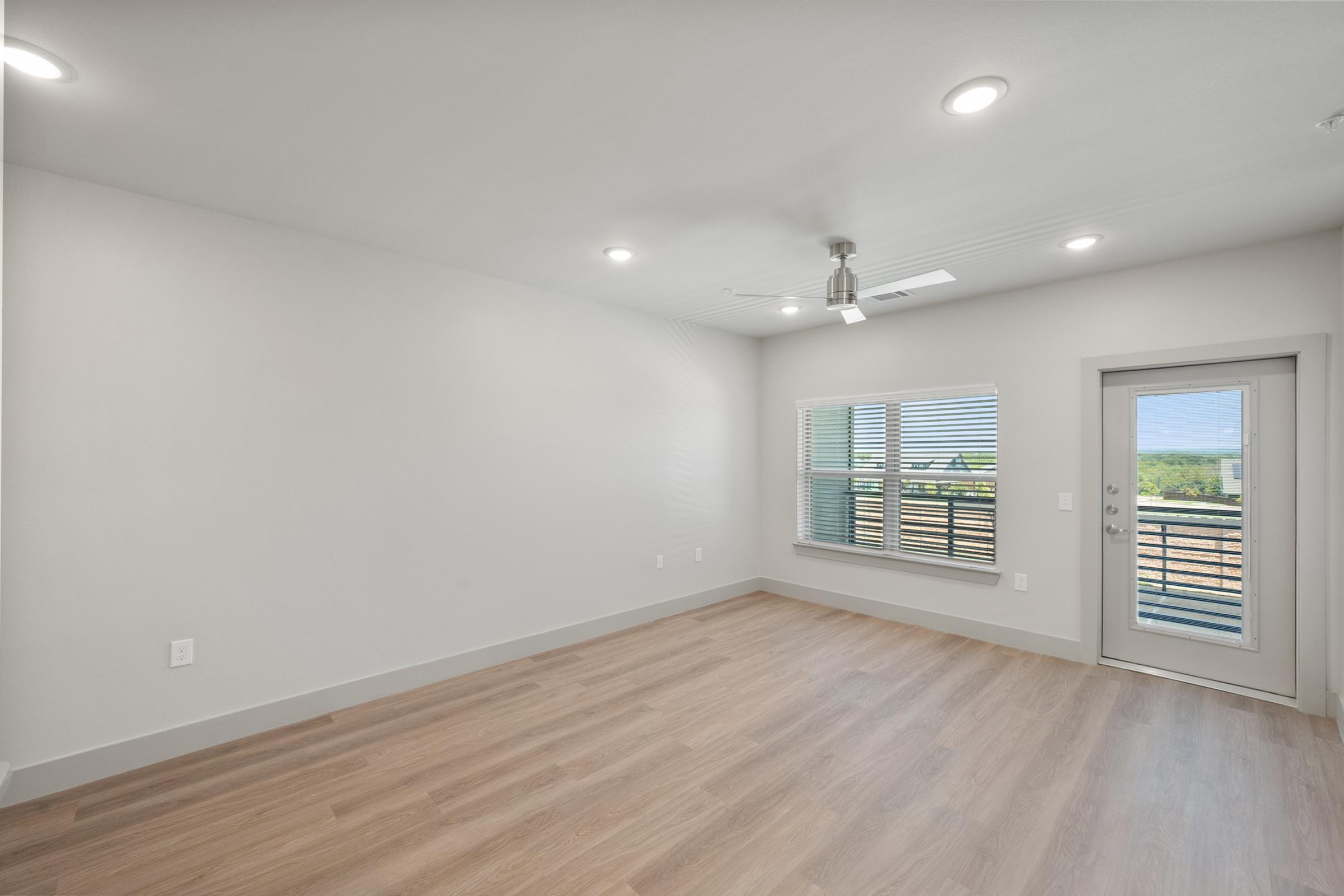 Open-concept living area in the A4 Floor Plan featuring high ceilings, natural light, and contemporary design