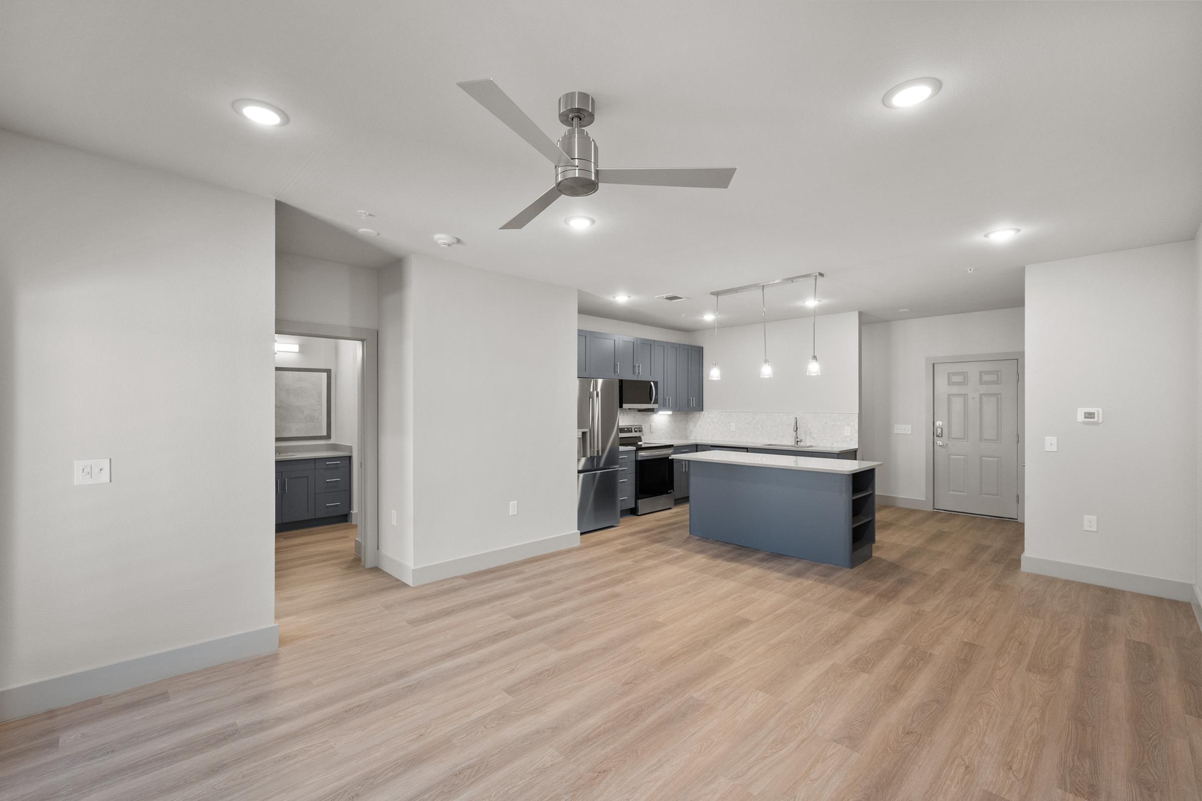 Open-concept living area in the A4 Floor Plan featuring high ceilings, natural light, and contemporary design