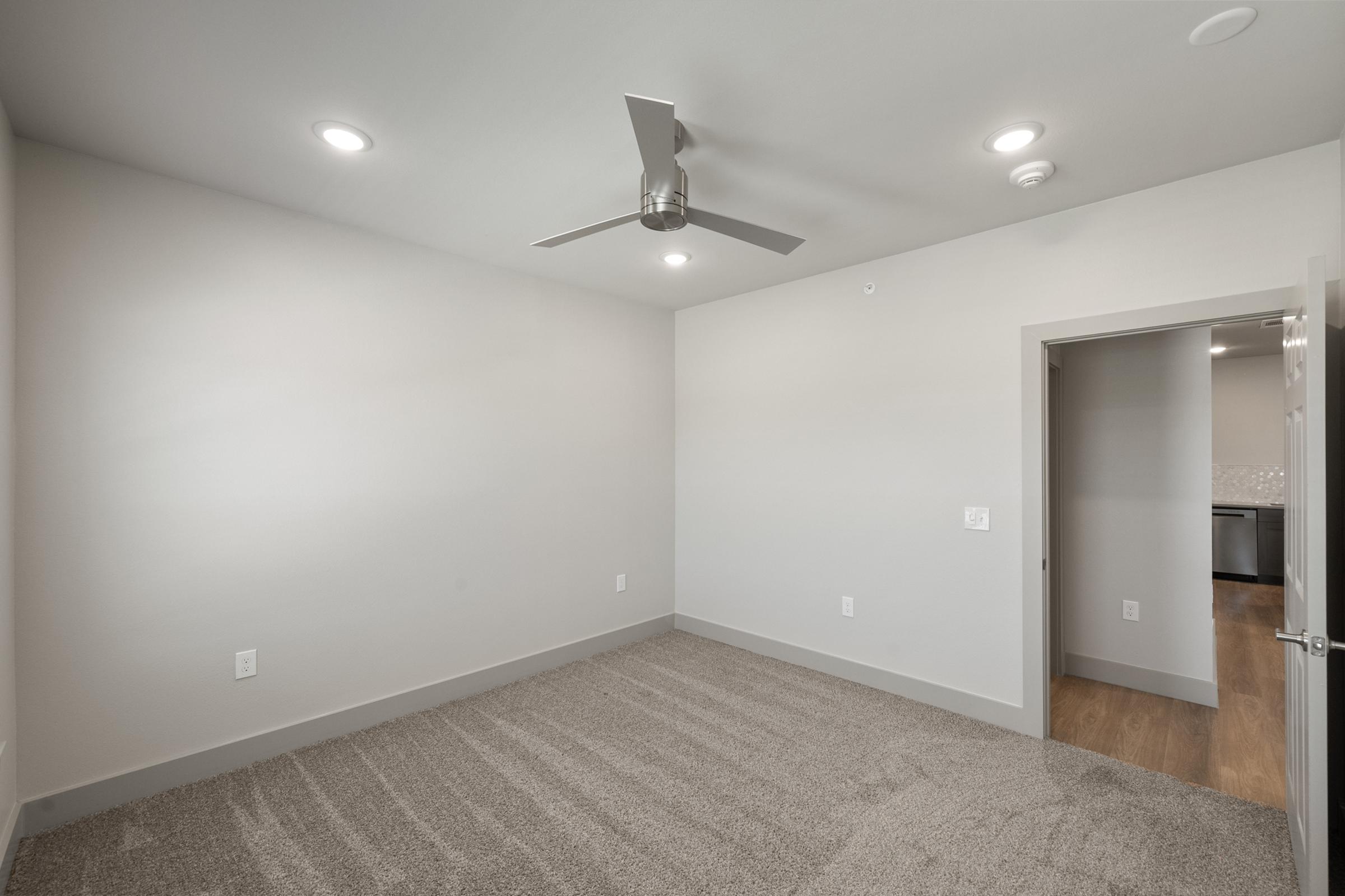 Spacious one-bedroom layout in the A4 unit with plush carpeting, ample natural light, and a large walk-in closet.
