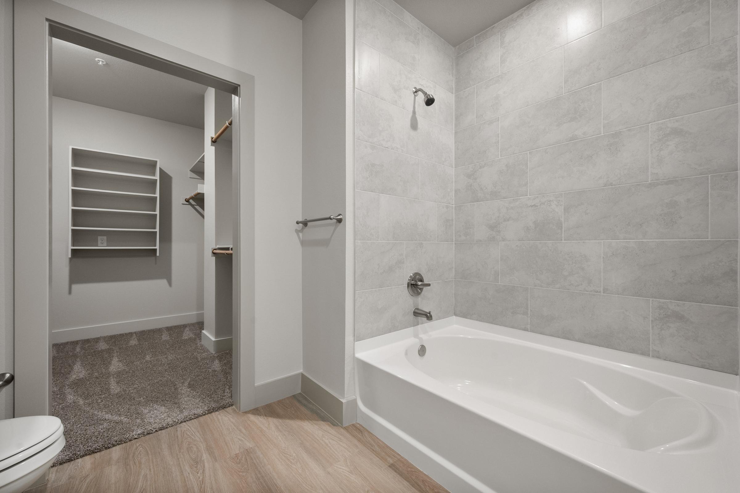 Bathroom in the A4 Floor Plan at The Emma Apartments featuring a shower-tub combination, modern fixtures, and a clean, contemporary design.