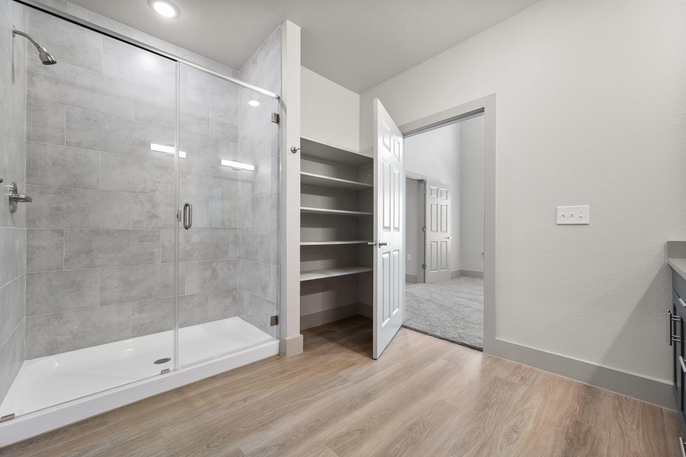 Primary bathroom with dual vanities, modern fixtures, and a clean, bright design for a spa-like feel.