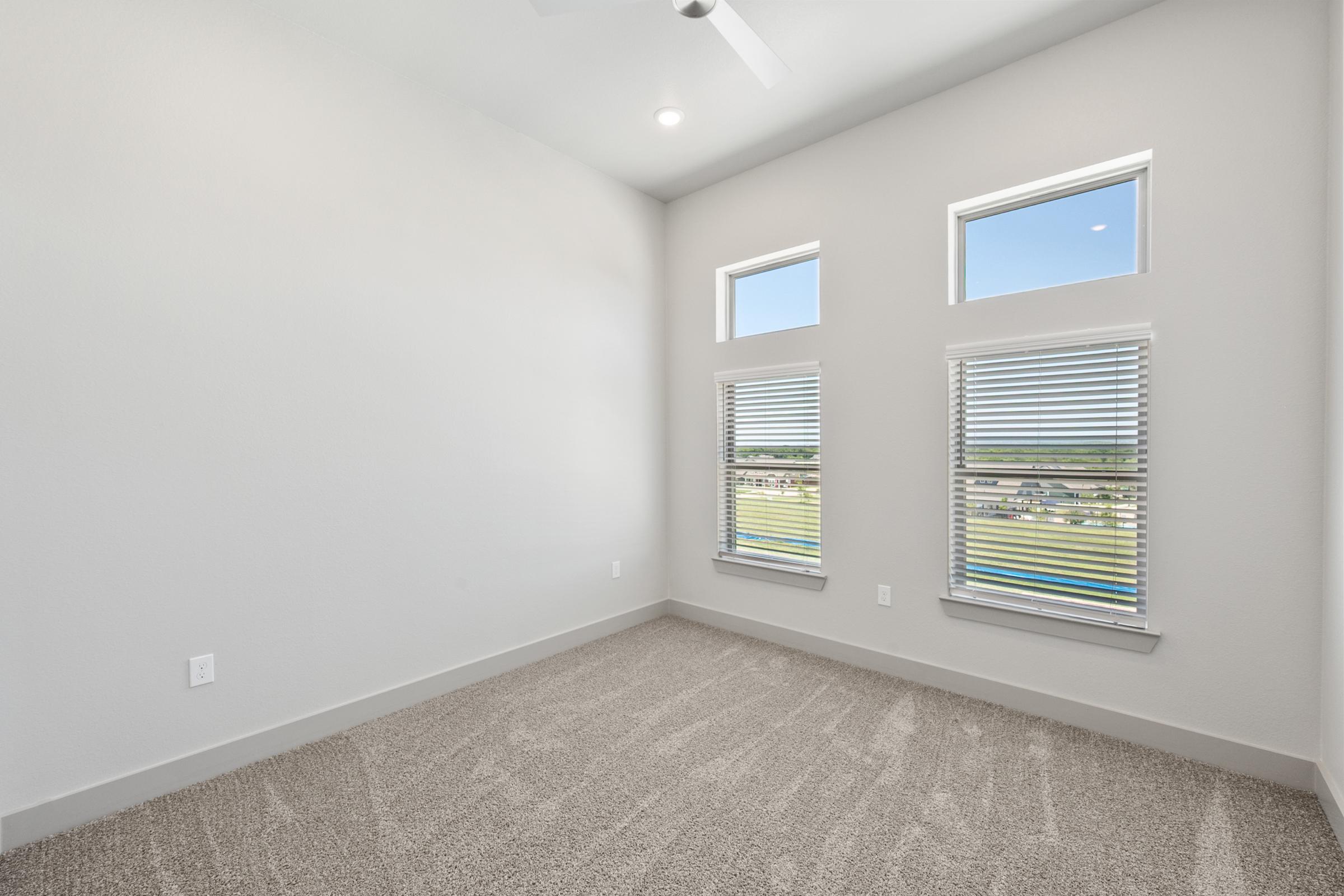 Comfortable second bedroom perfect for guests, a home office, or nursery, with plush carpeting and a spacious closet.
