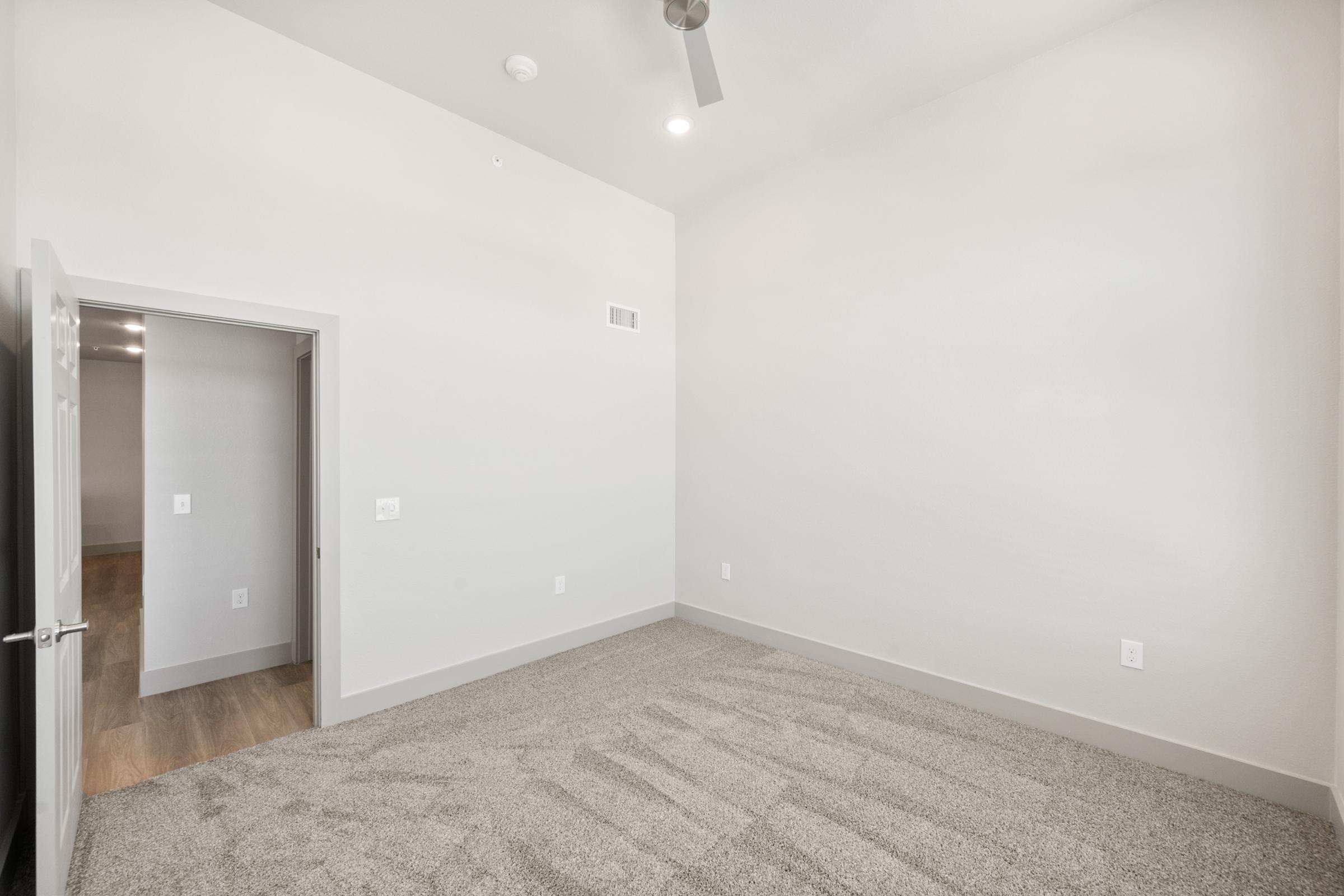 Comfortable second bedroom perfect for guests, a home office, or nursery, with plush carpeting and a spacious closet.