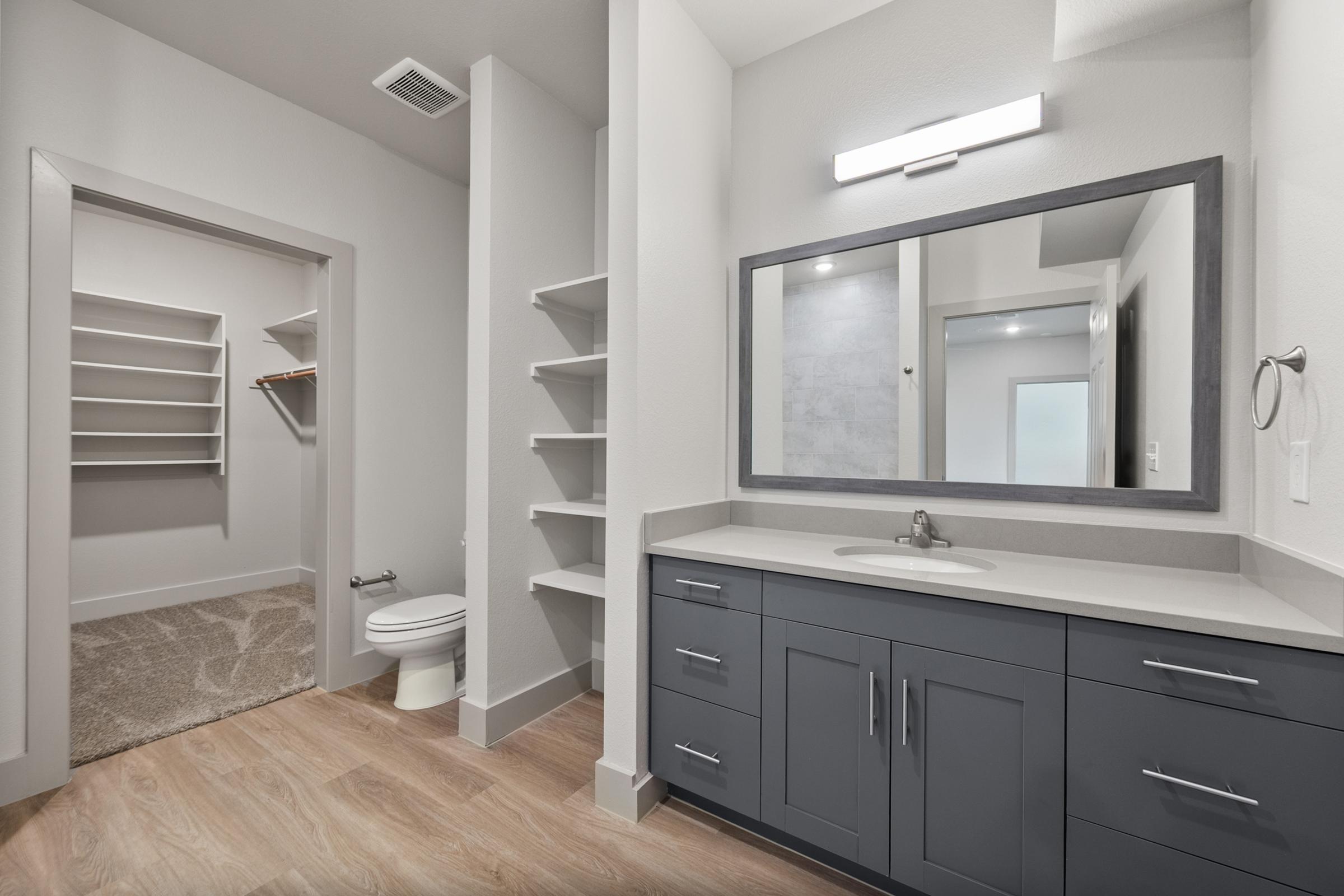 Secondary bathroom in the B1 Floor Plan at The Emma Apartments featuring a tub-shower combo, sleek fixtures, and a modern, clean design.