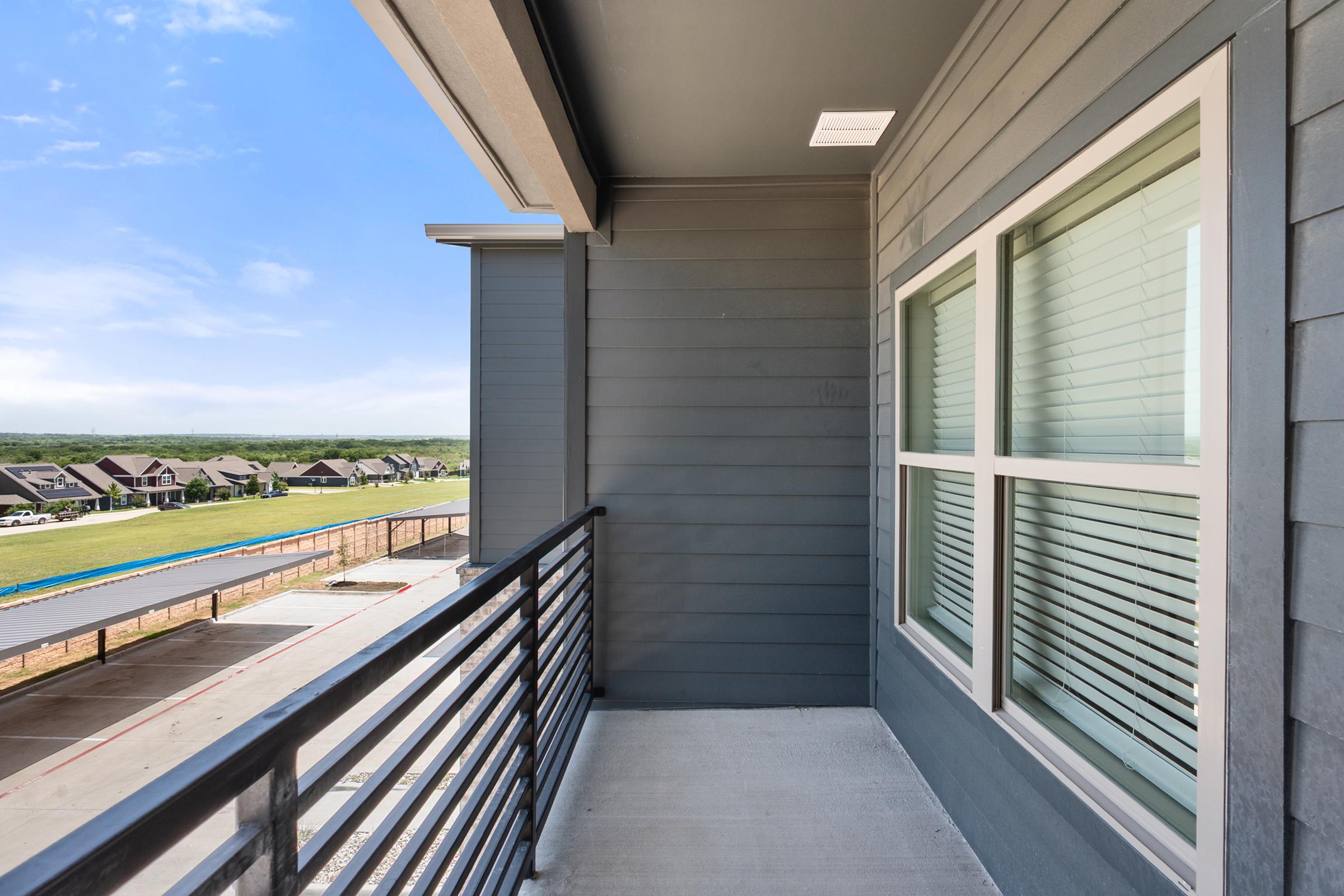 Private patio or balcony in the B1 Floor Plan at The Emma Apartments, offering outdoor space for relaxing, dining, or enjoying fresh air.