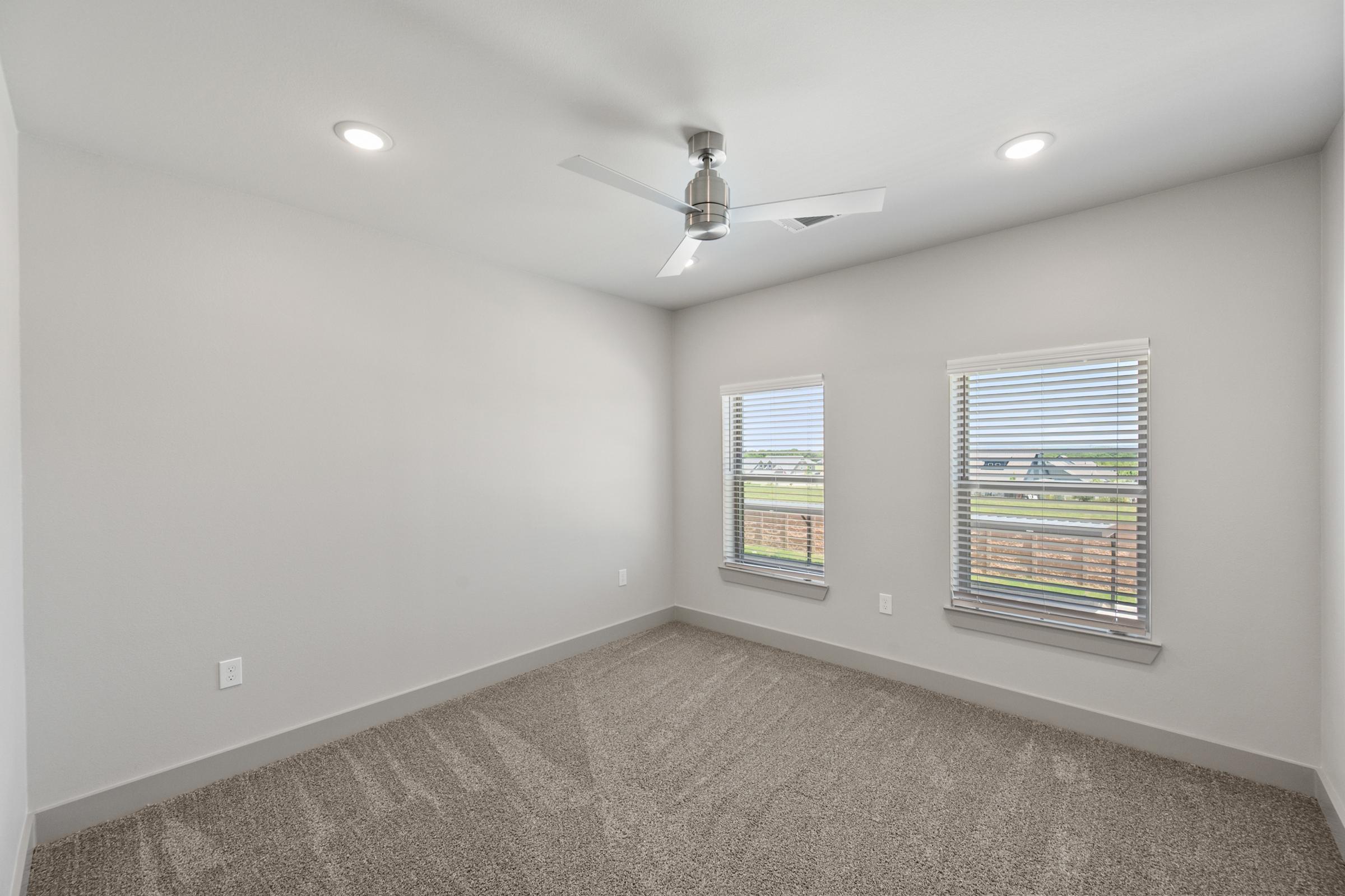 Secondary bedroom with soft carpeting, generous closet space, and easy access to the hall bathroom—ideal for guests or roommates.