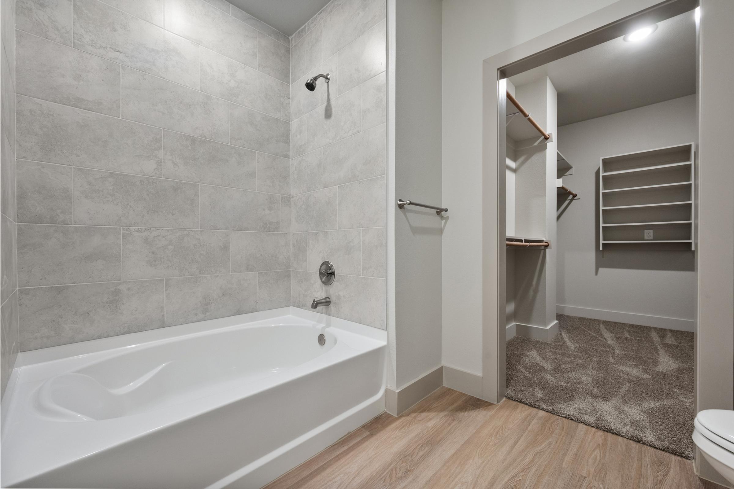 Full secondary bathroom with a shower-tub combination, modern finishes, and convenient location near the second bedroom.