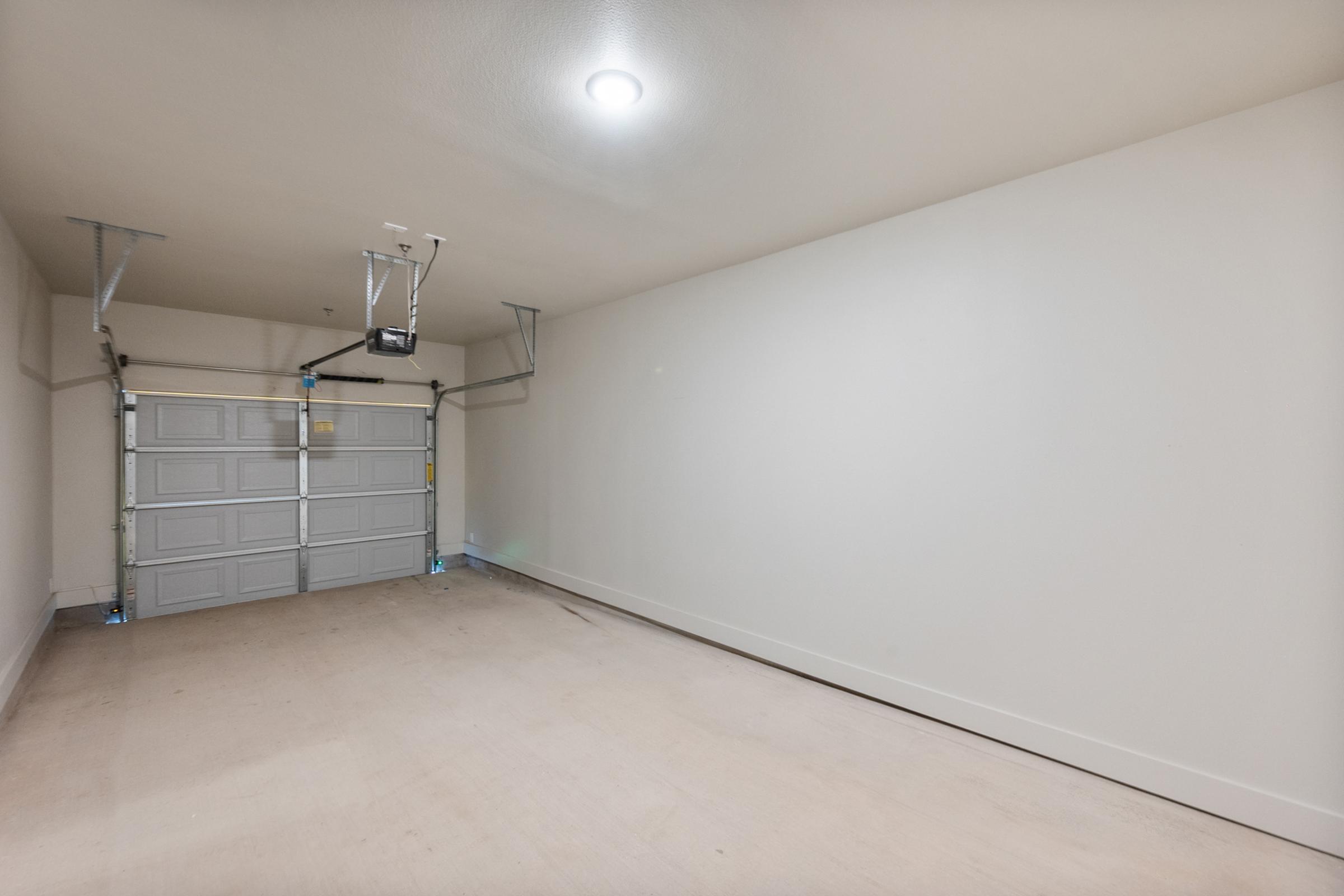 Attached private garage with interior stairs providing direct access to the main living space in the B2 townhome-style unit.