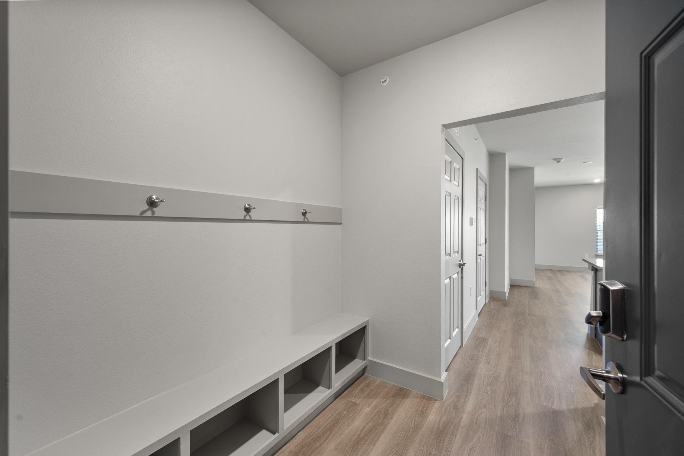 Mudroom entry in the C1 Floor Plan with built-in bench seating, wall hooks, and storage cubbies for organized, convenient everyday access.