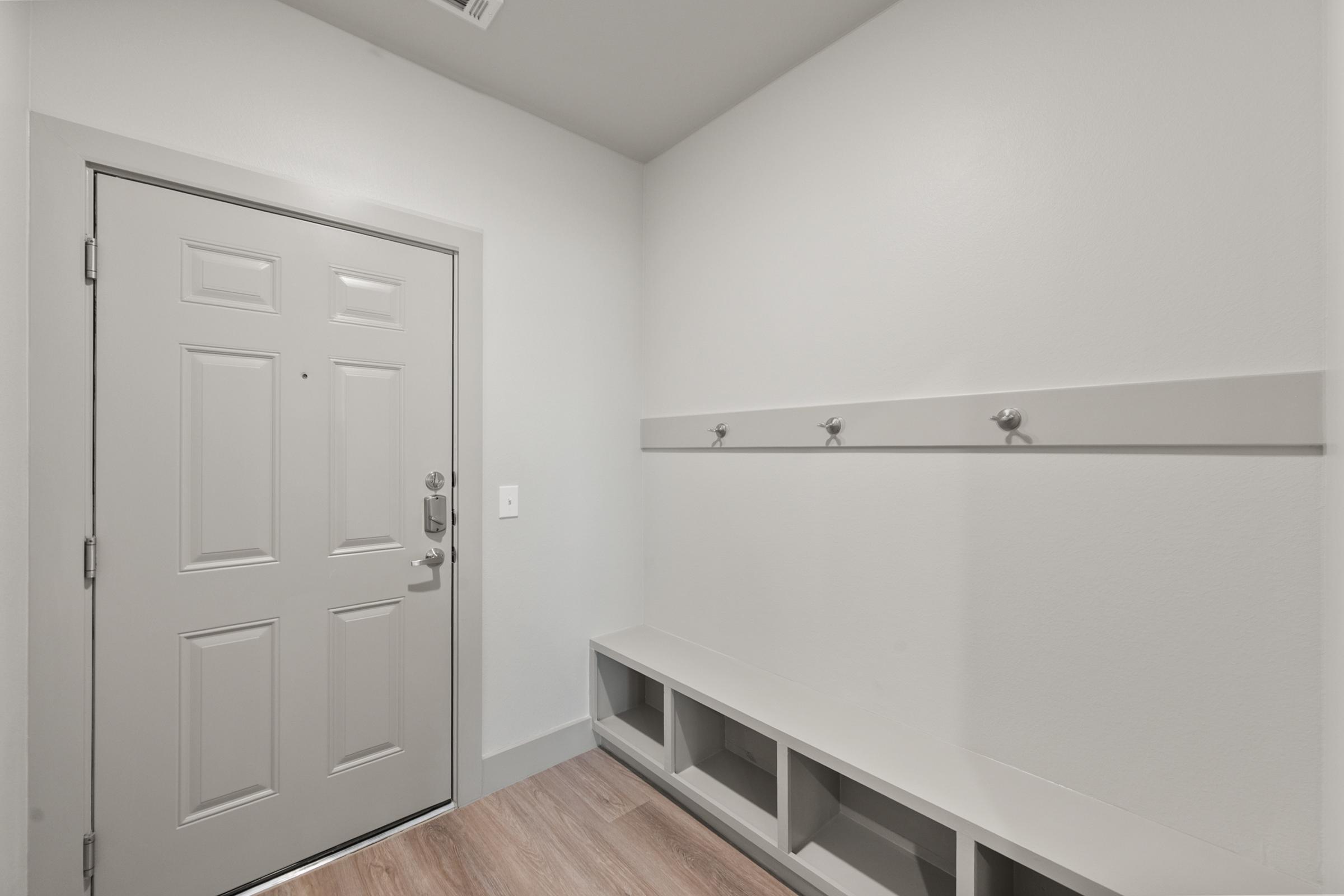 Mudroom entry in the C1 Floor Plan with built-in bench seating, wall hooks, and storage cubbies for organized, convenient everyday access.