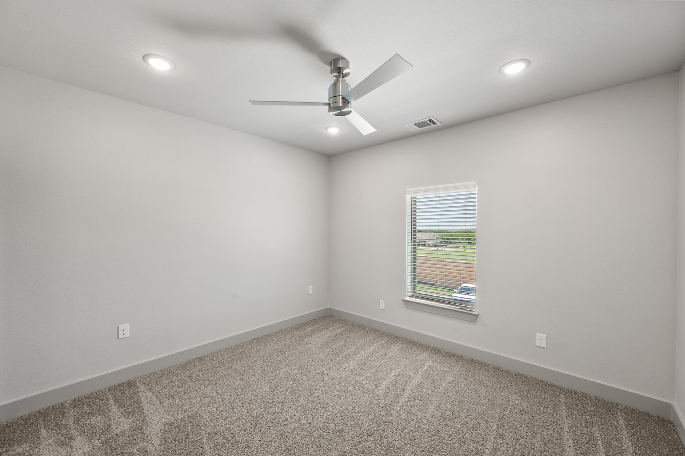 Comfortable secondary bedroom in the C1 Floor Plan with carpeted flooring and a generously sized closet for added storage.