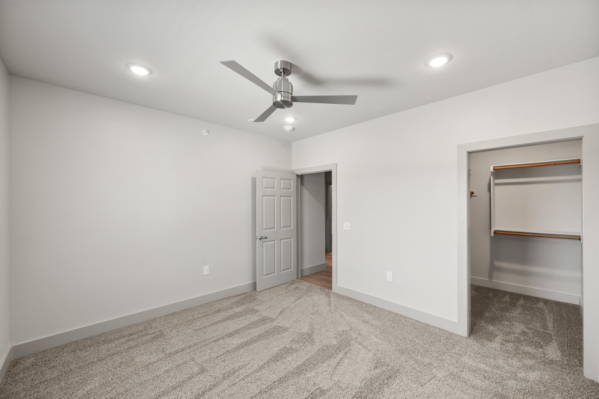 Comfortable secondary bedroom in the C1 Floor Plan with carpeted flooring and a generously sized closet for added storage.