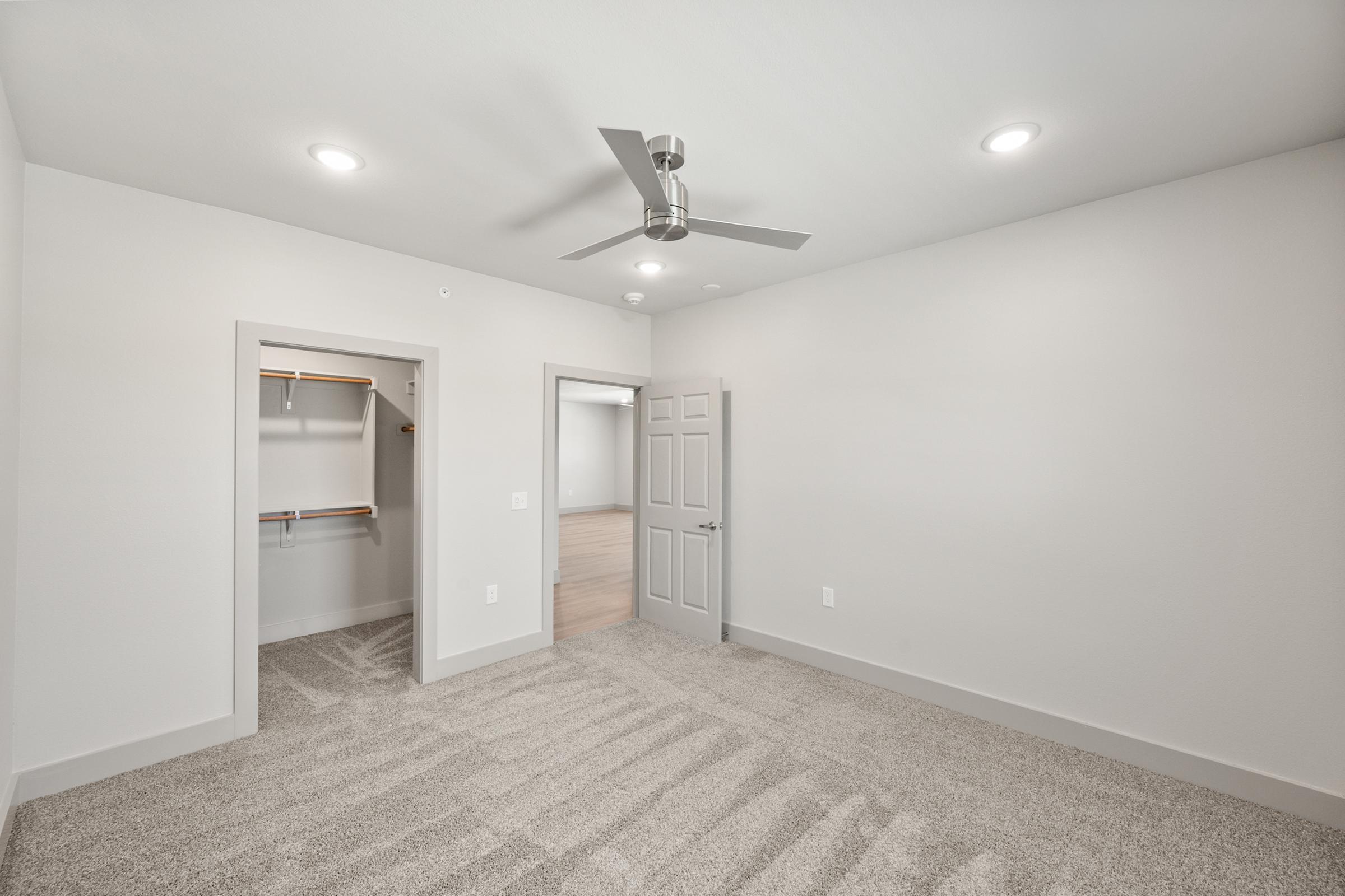 Versatile third bedroom perfect for guests, a home office, or nursery, complete with a large window and spacious closet.