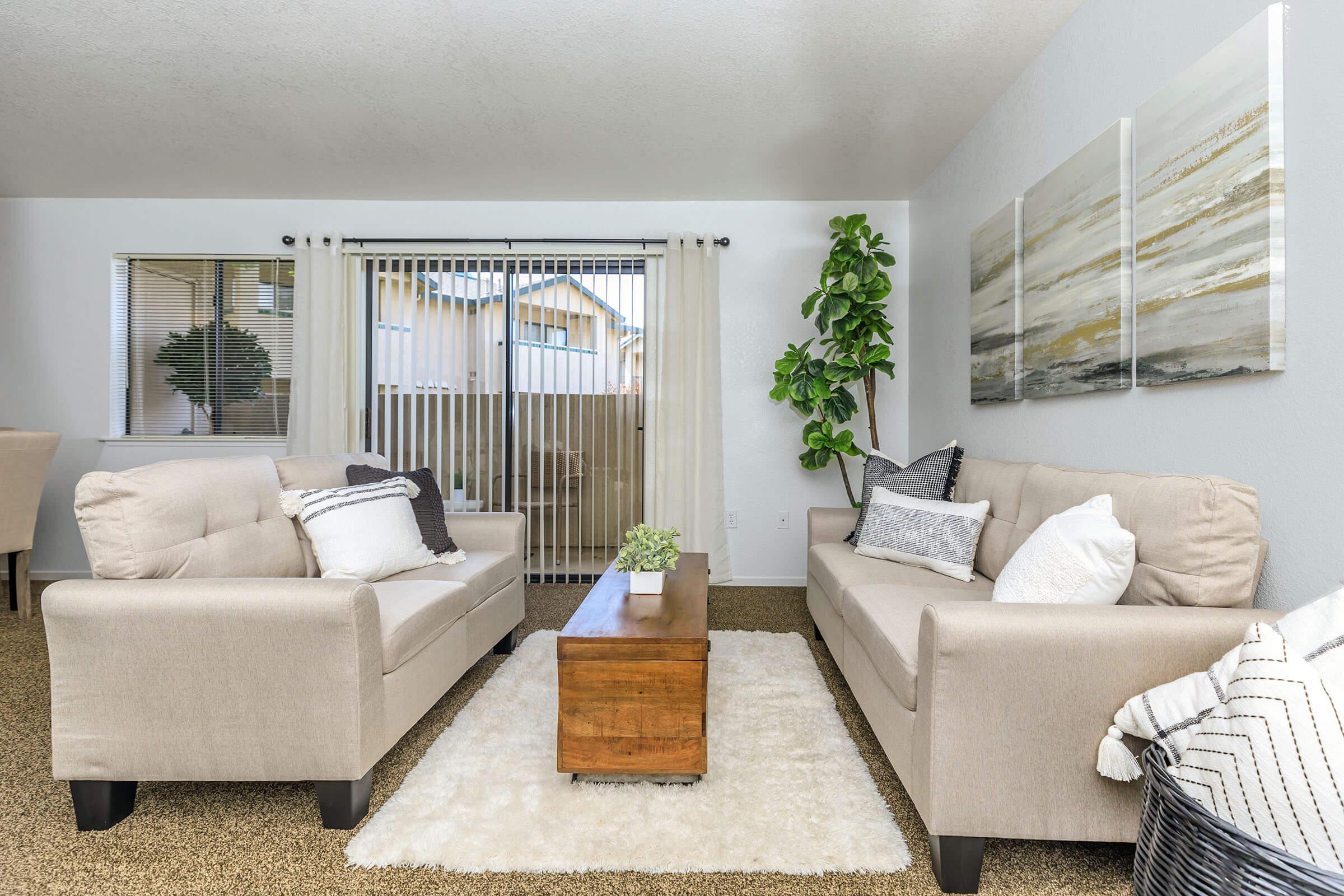 a living room filled with furniture and a large window