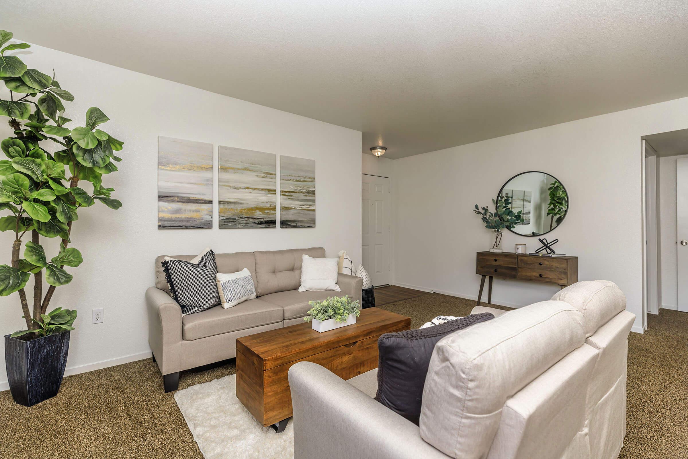 a living room filled with furniture and a flat screen tv