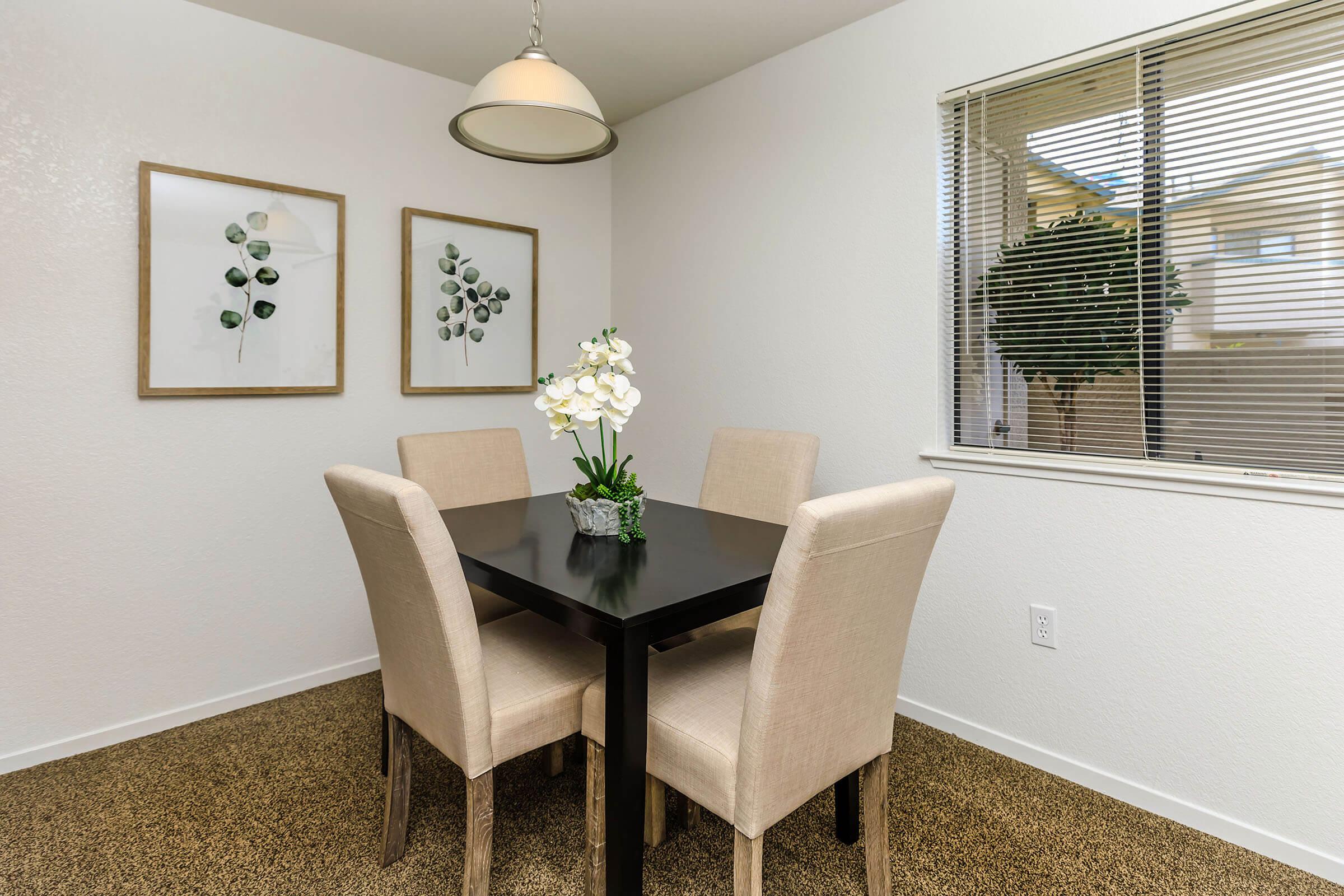 a room filled with furniture and vase of flowers on a table