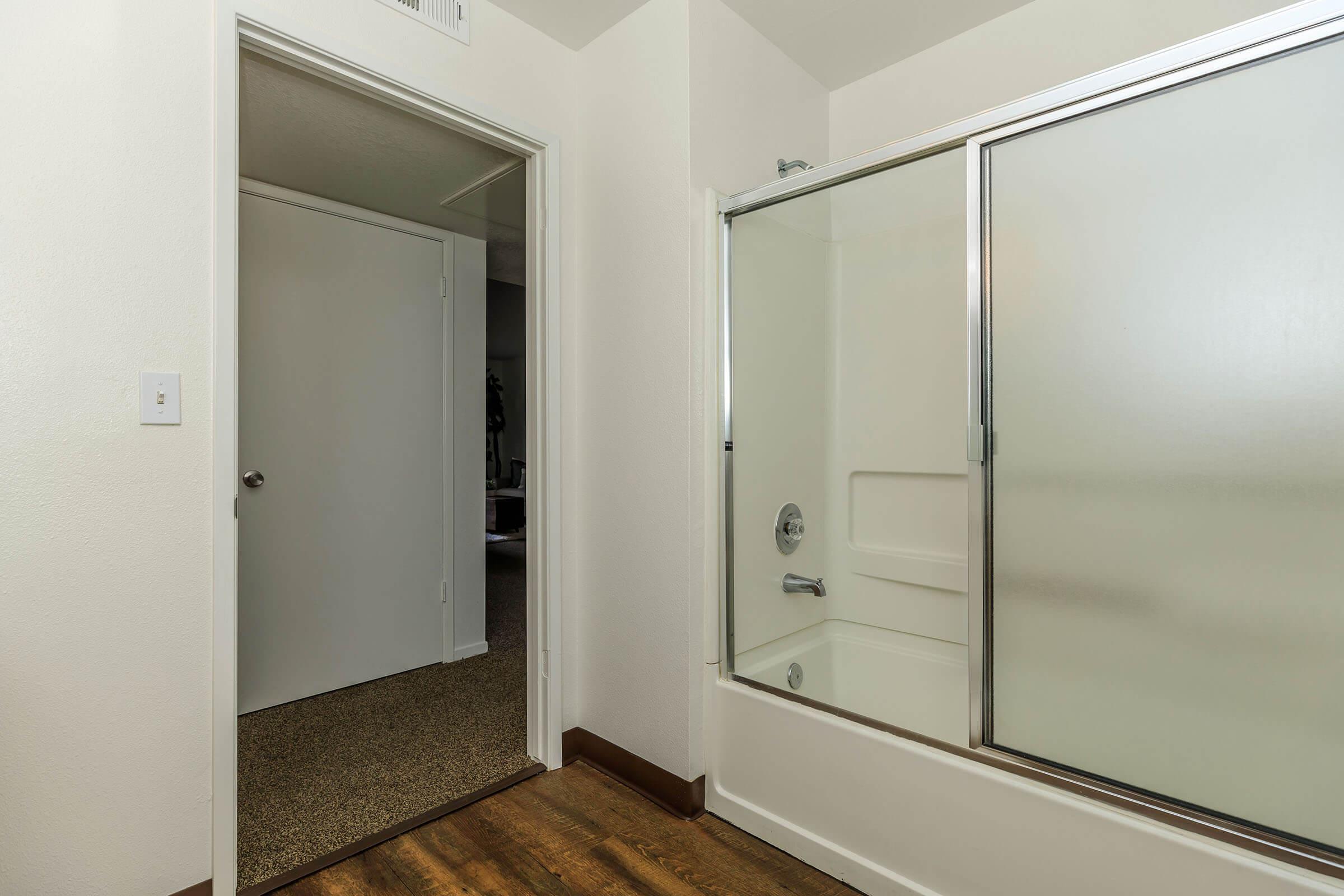 a shower that has a sink and a mirror