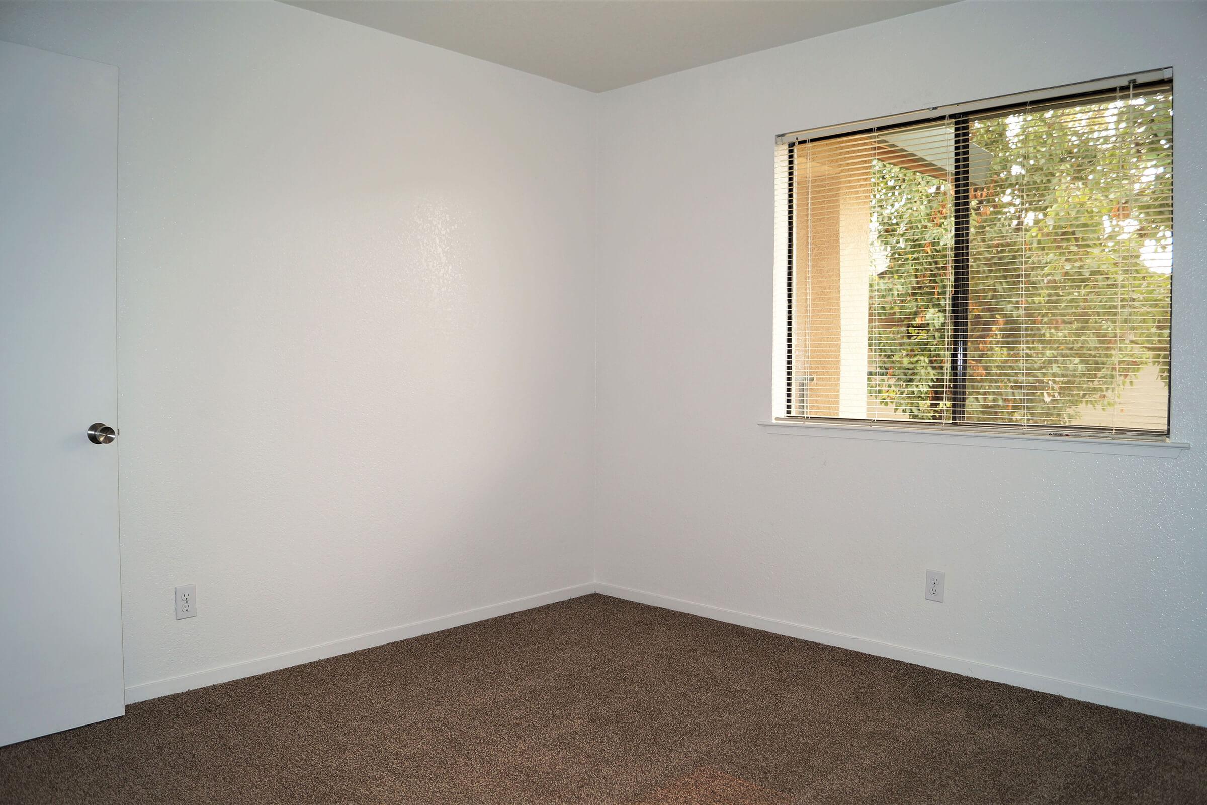 a bedroom with a large window