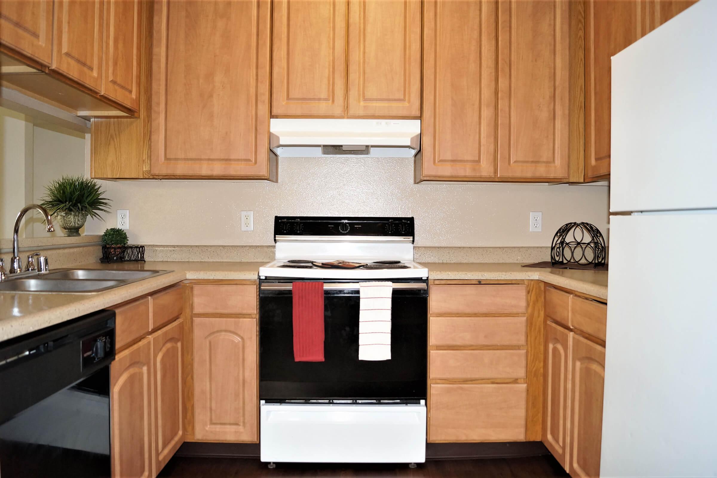 a kitchen with wooden cabinets and a black stove top oven