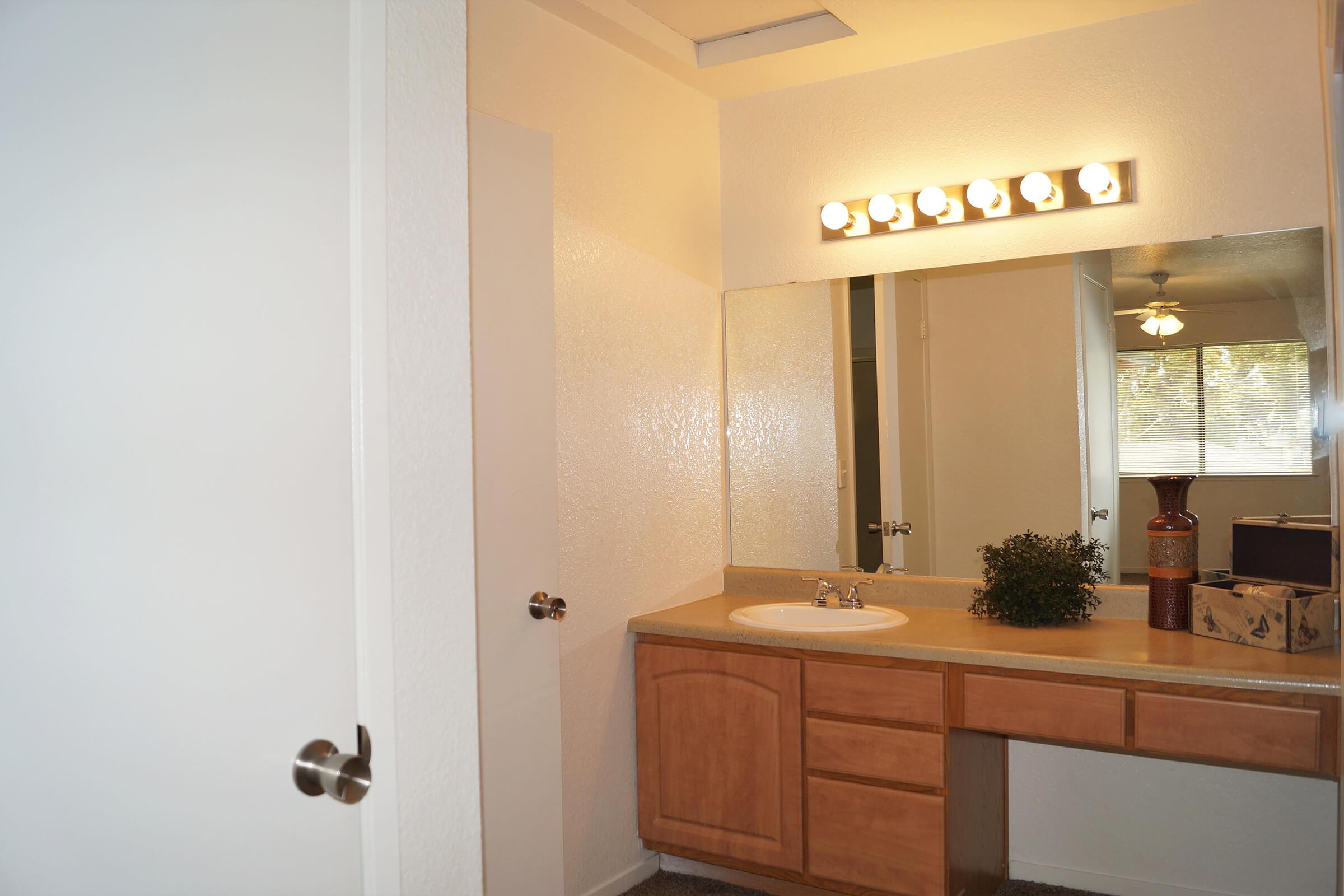 a kitchen with a sink and a mirror