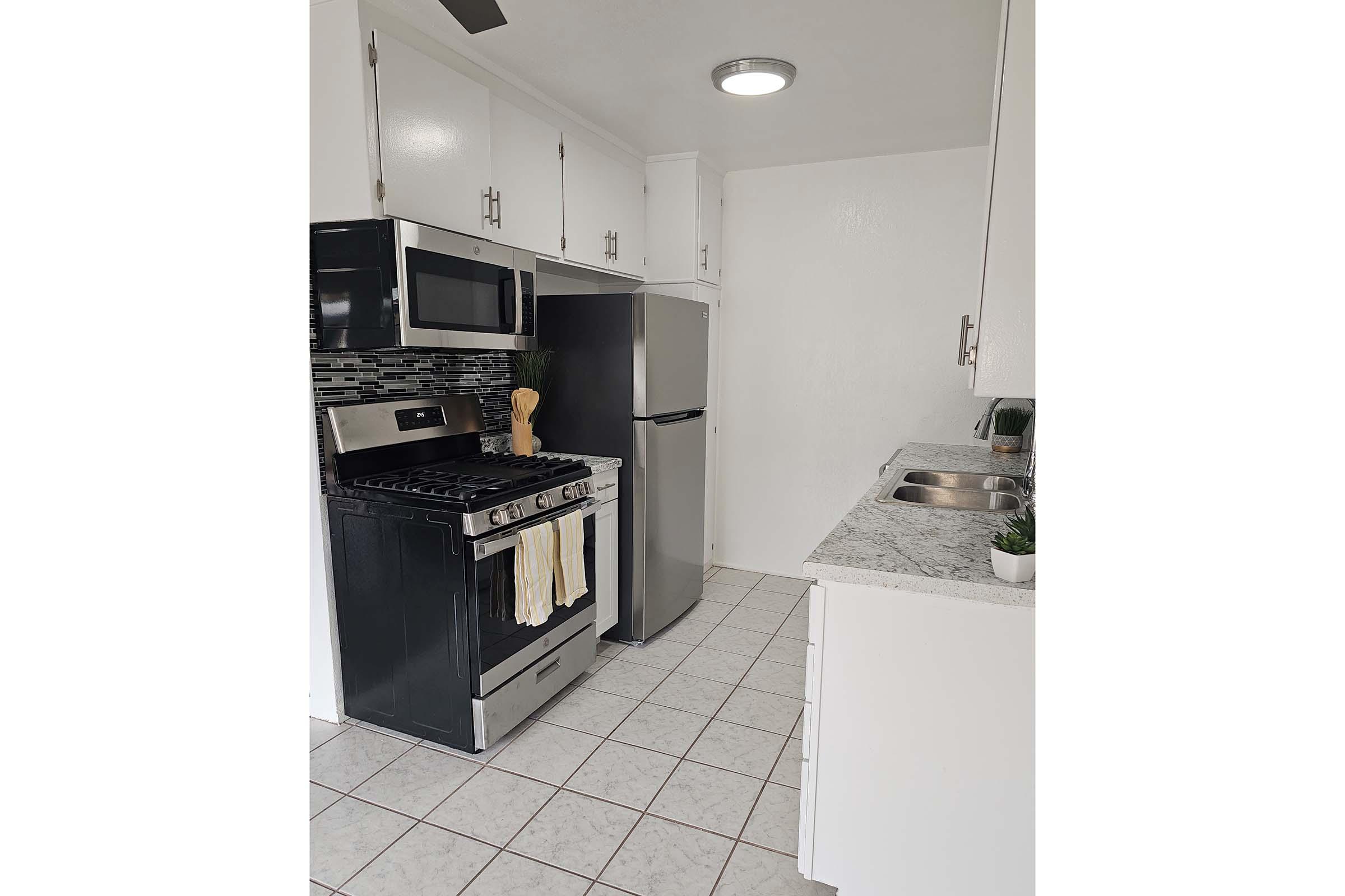 a stove top oven sitting inside of a kitchen