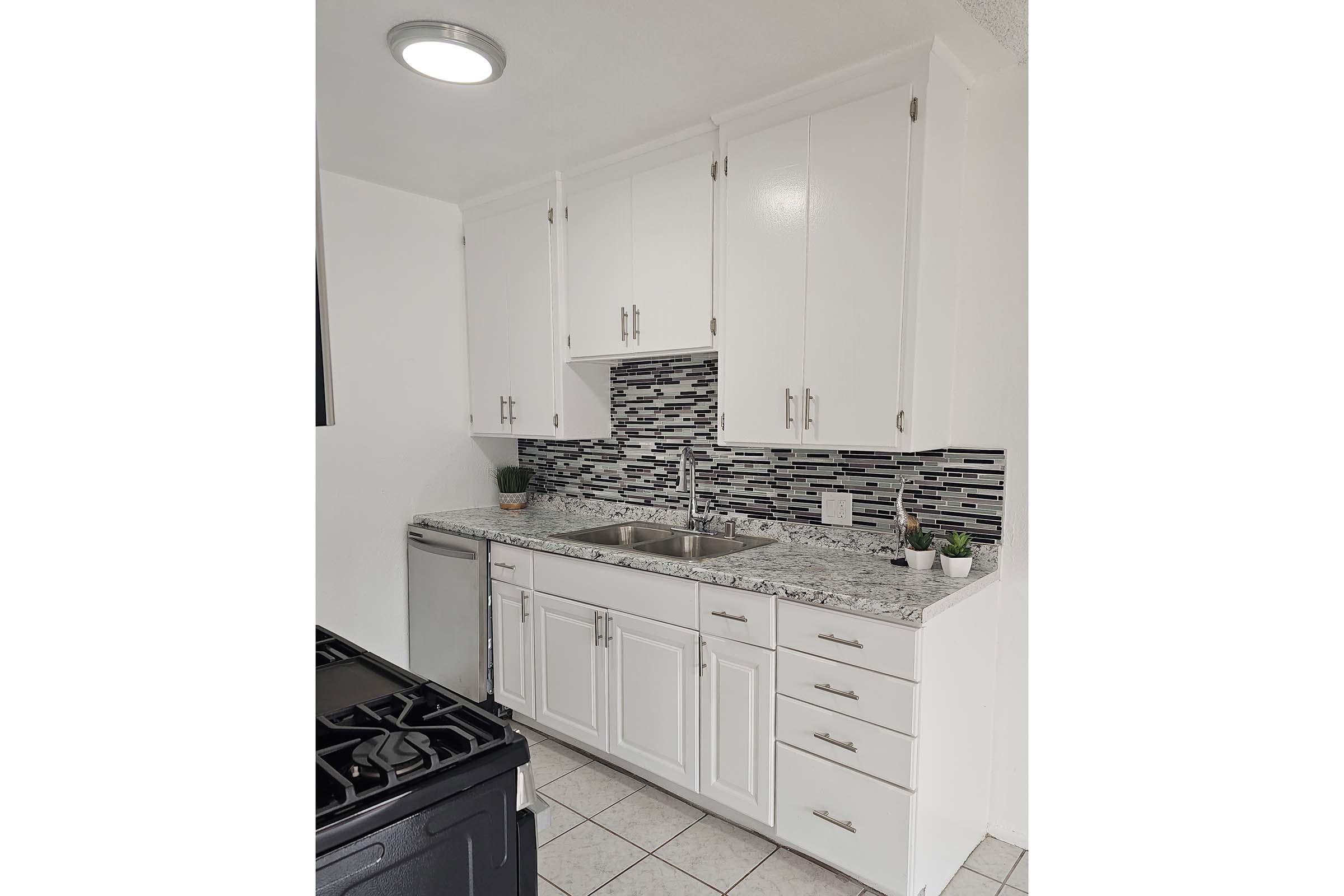 a kitchen with a stove and a refrigerator