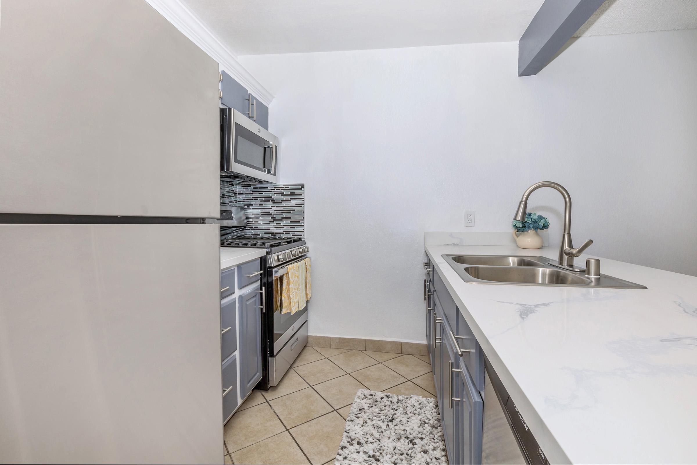 a kitchen with a sink and a refrigerator