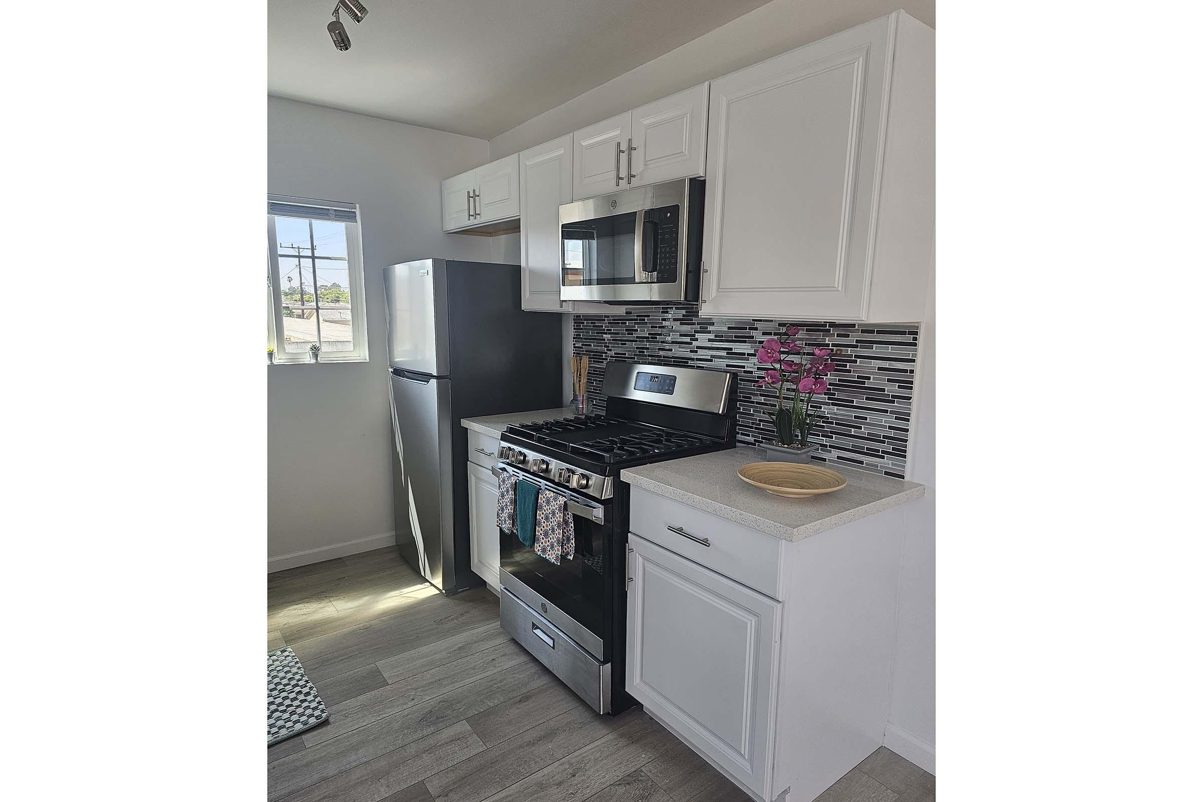 a kitchen with a stove and a refrigerator