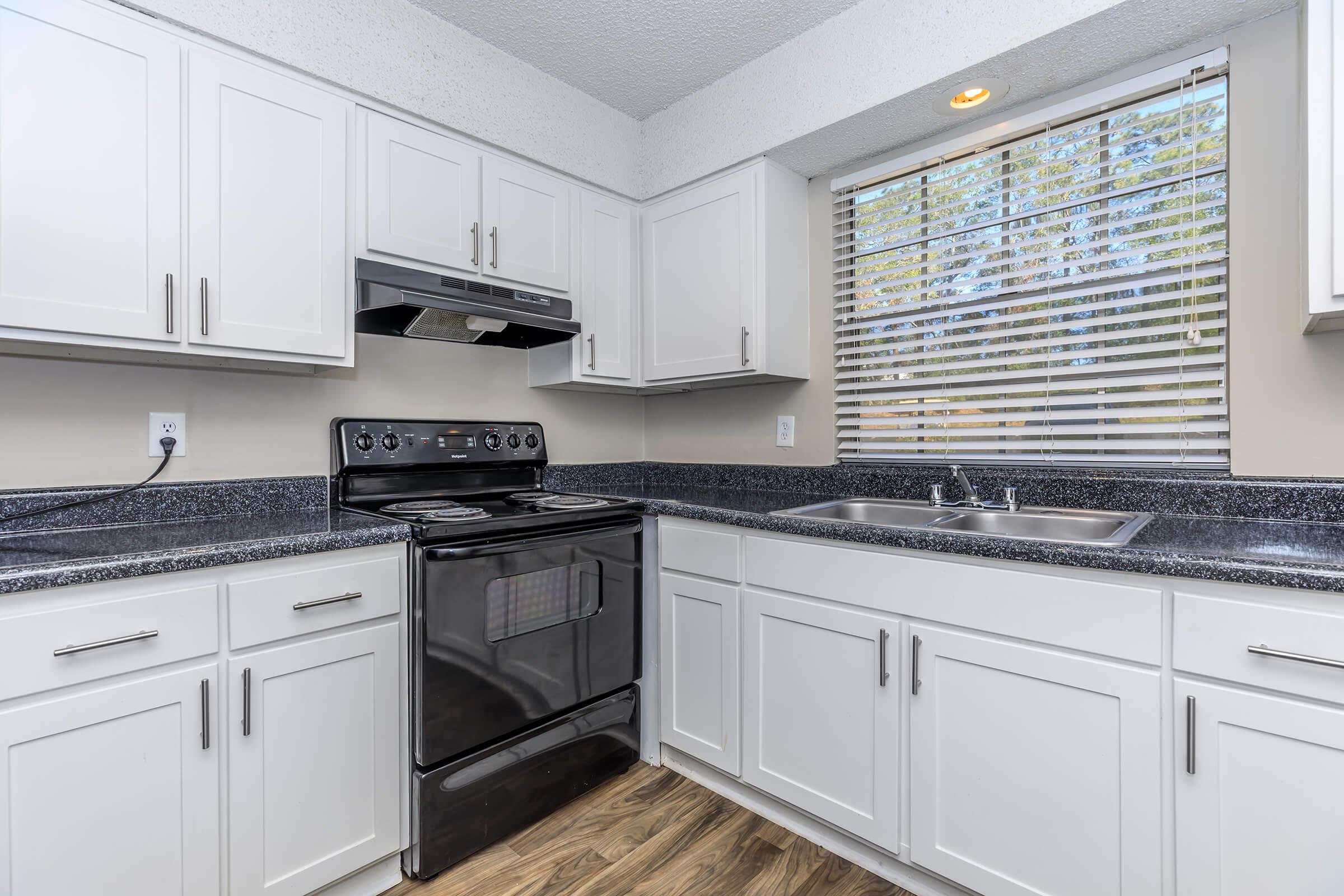 a kitchen with a stove a sink and a microwave