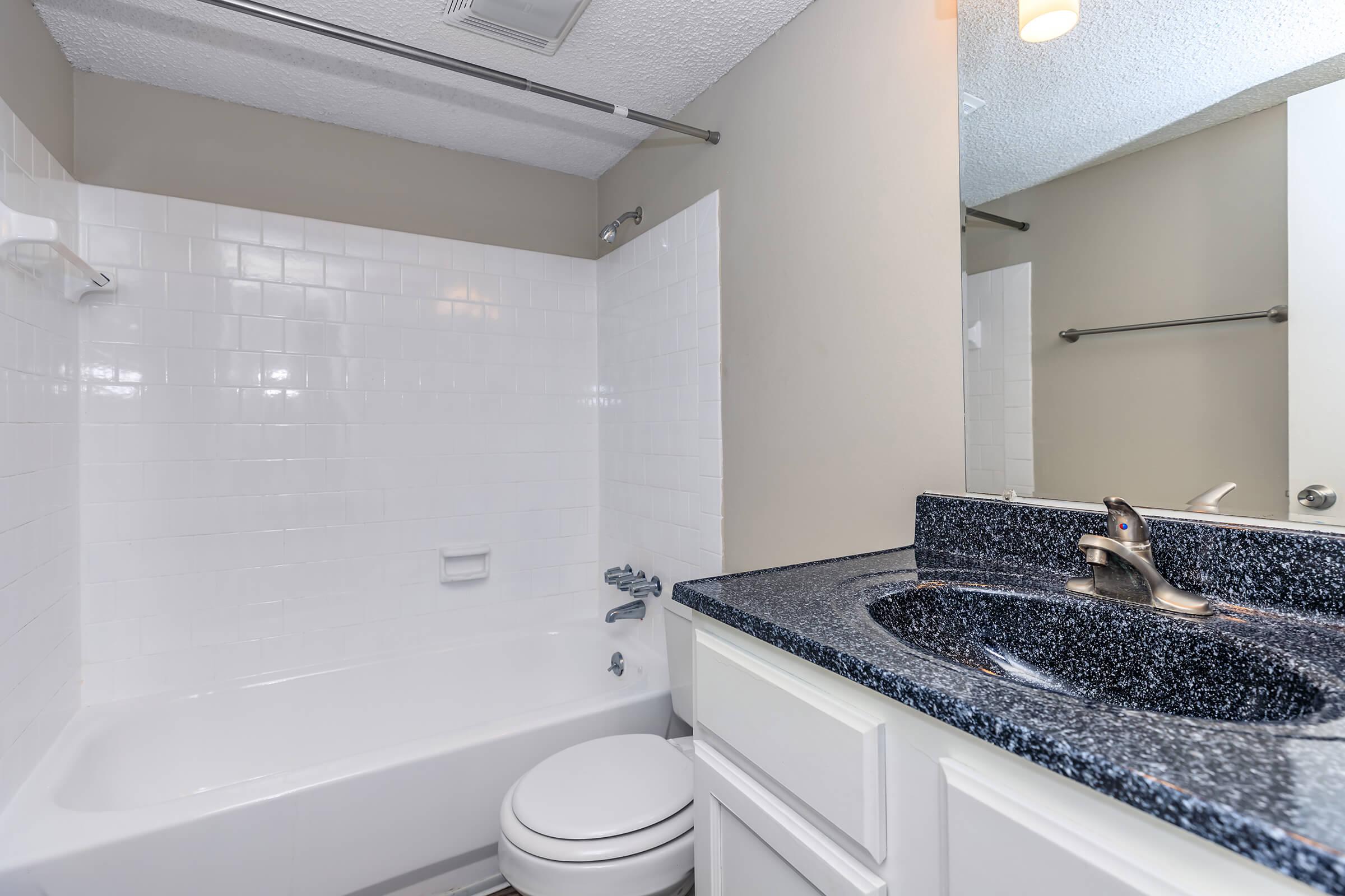 a kitchen with a sink and a mirror