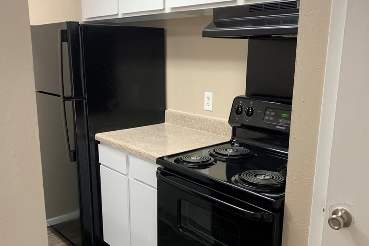 a kitchen with a stove top oven sitting inside of a refrigerator