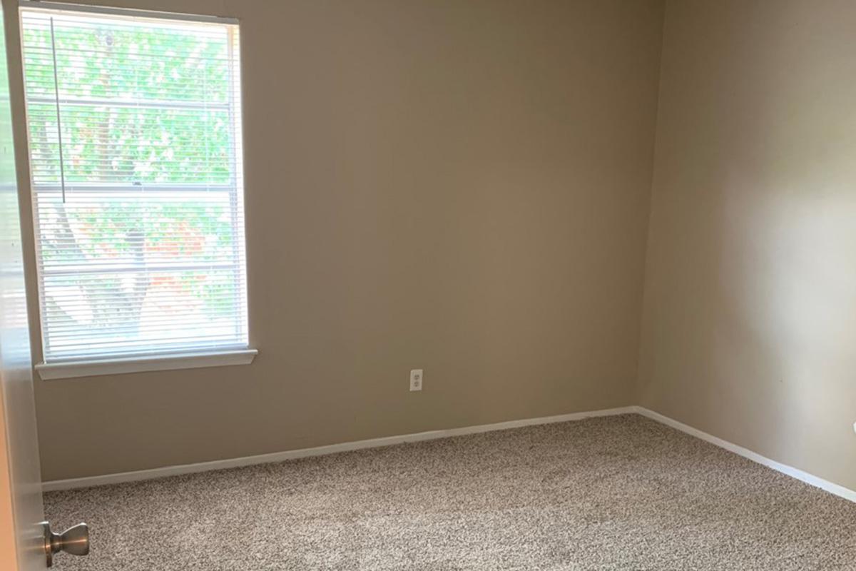 a bedroom with a large window