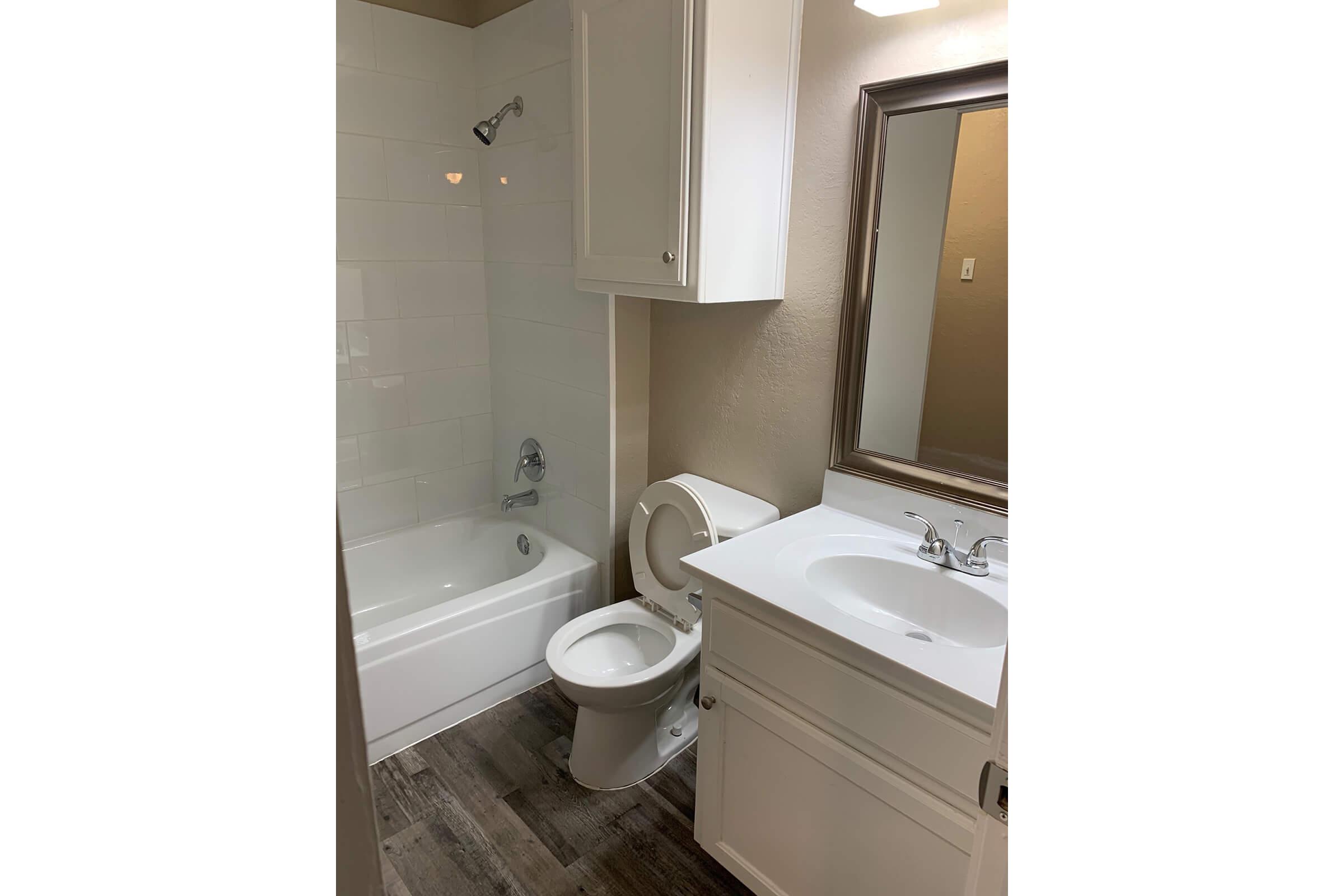 a white tub sitting next to a sink