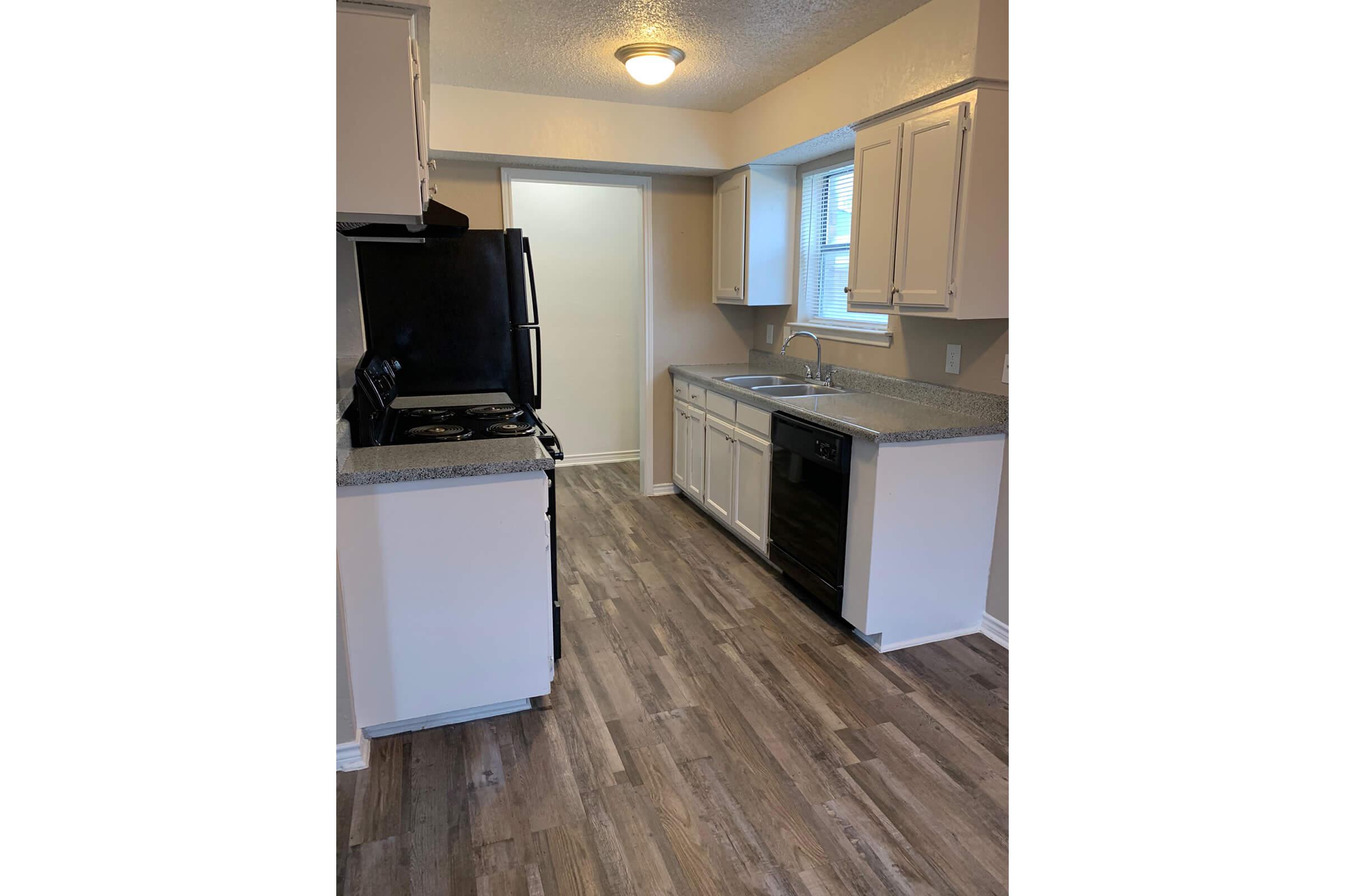 a kitchen with a stove and a refrigerator