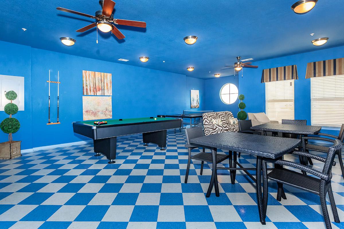 a dining room table with a blue chair