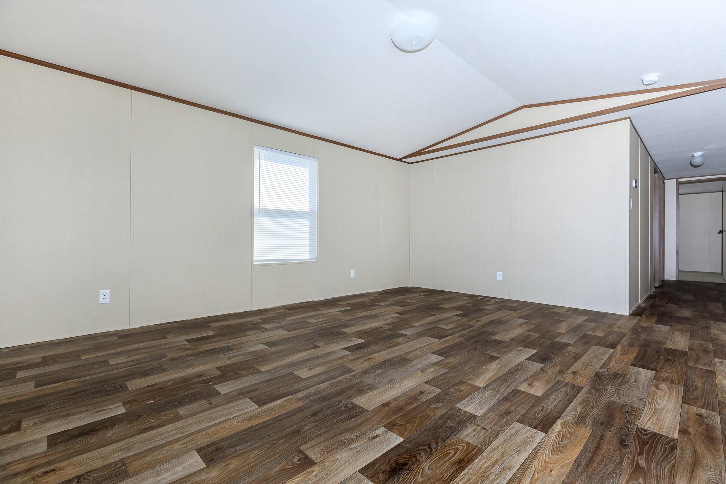 a bedroom with a wooden floor