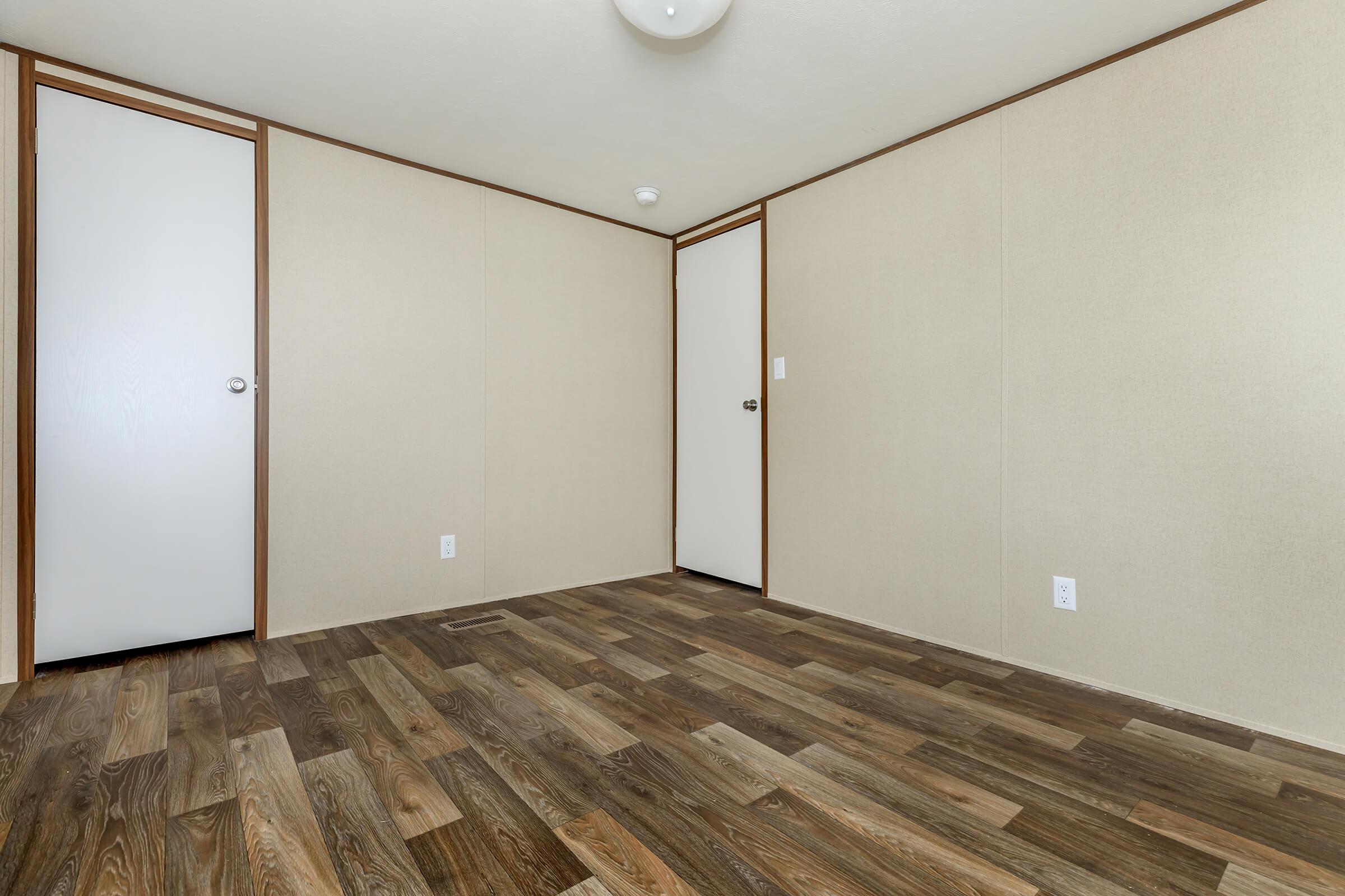 a bedroom with a wooden floor