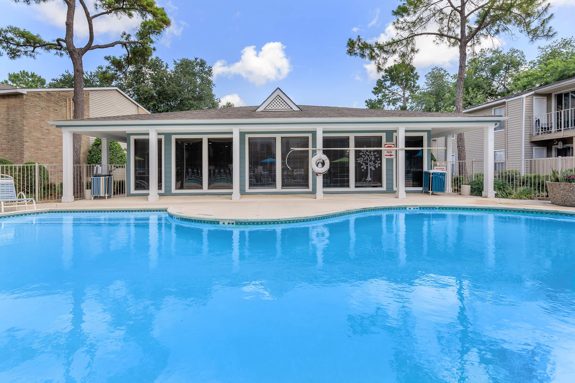 a large pool of water in front of a house