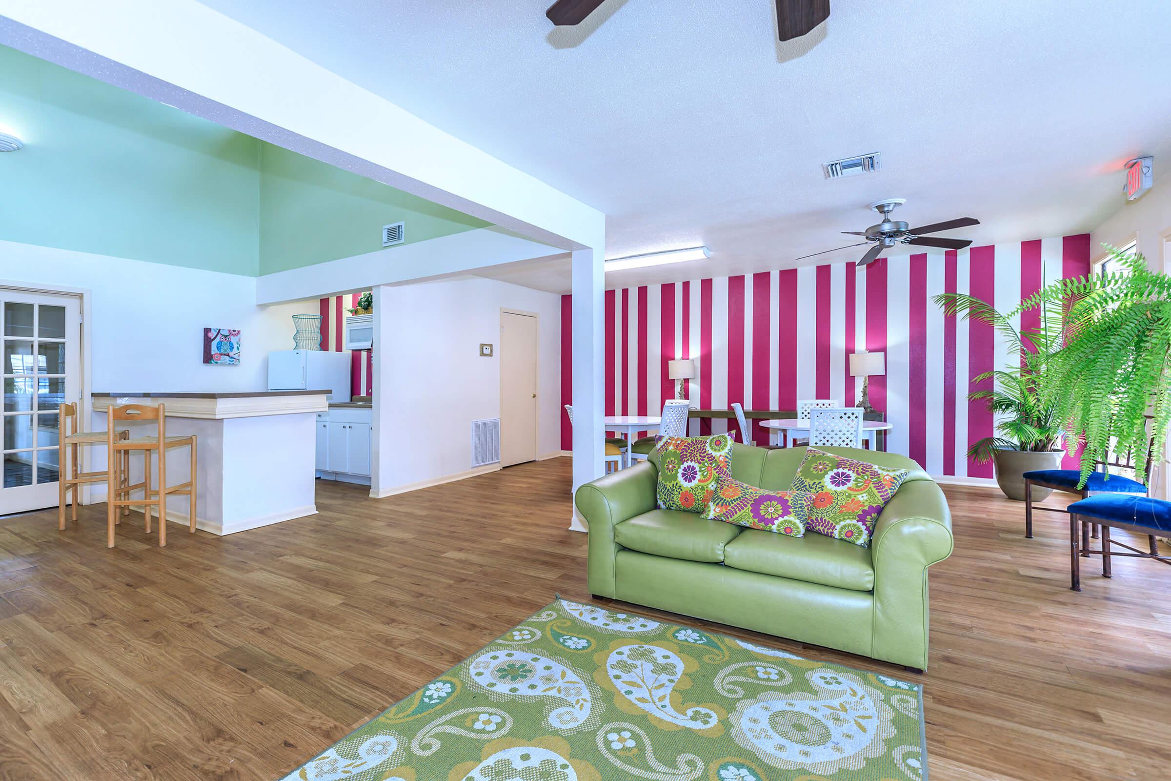 a living room filled with furniture and a large window